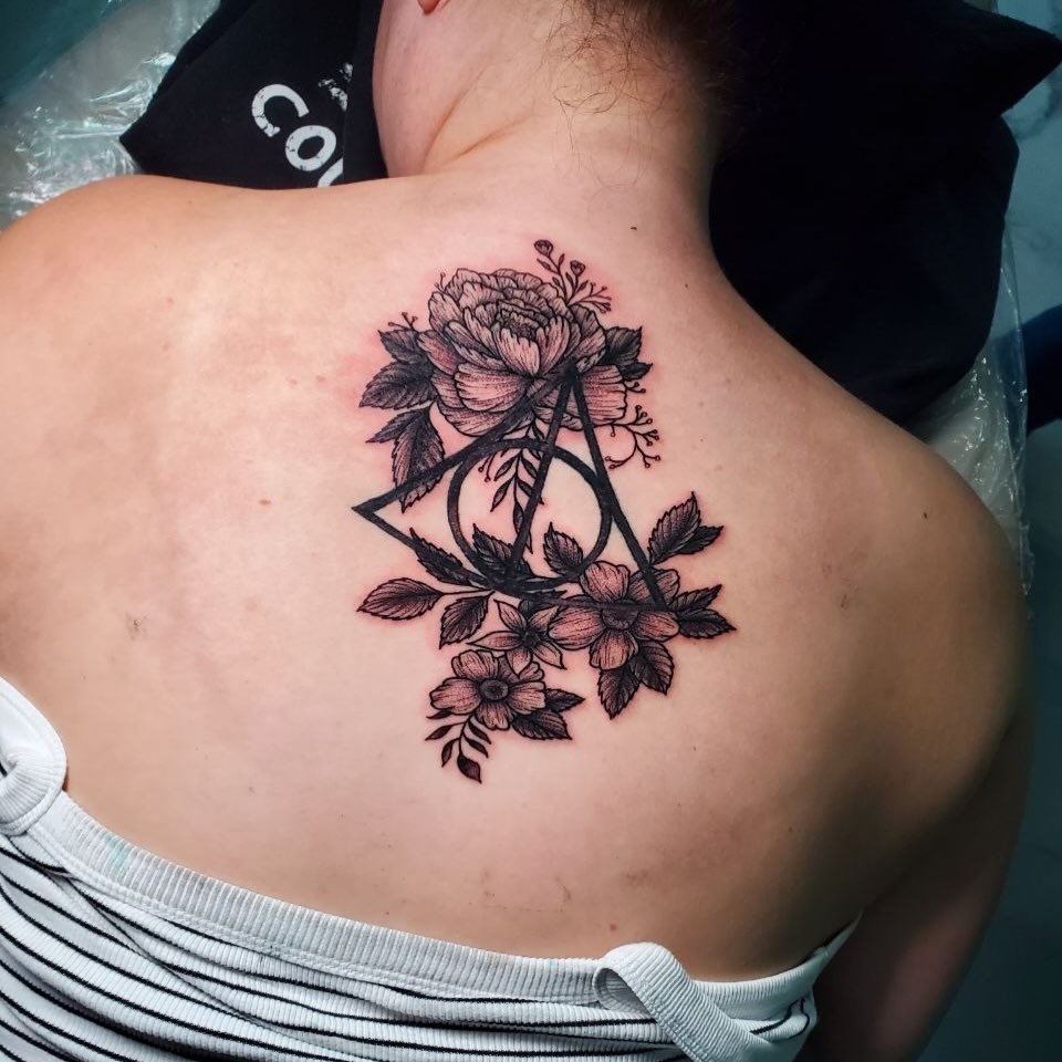 Deathly hallows and flowers black and grey tattoo on the back by Matthew Ray, Harrisburg, North Carolina