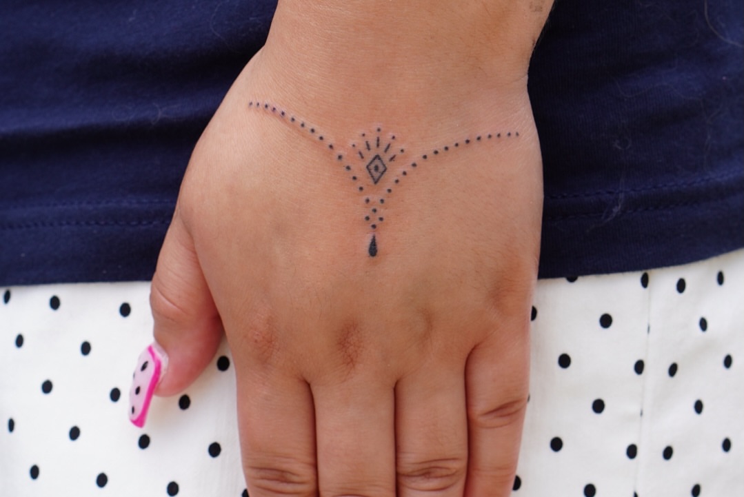 Geometric design dotwork tattoo on the hand by IVY K ༄ ATX Handpoke Artist