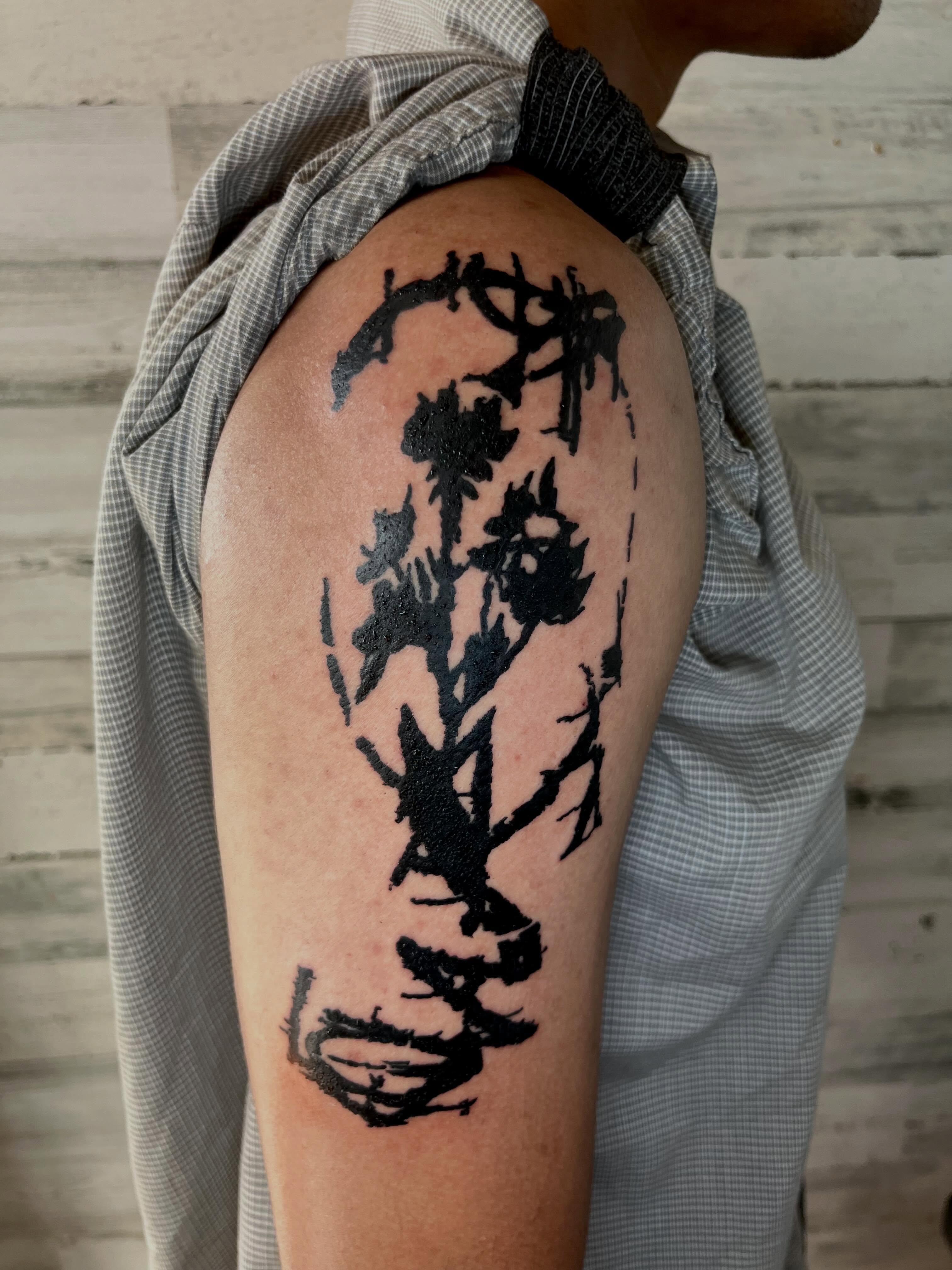 Abstract floral black and grey tattoo on the shoulder by @godsfirmgrip
