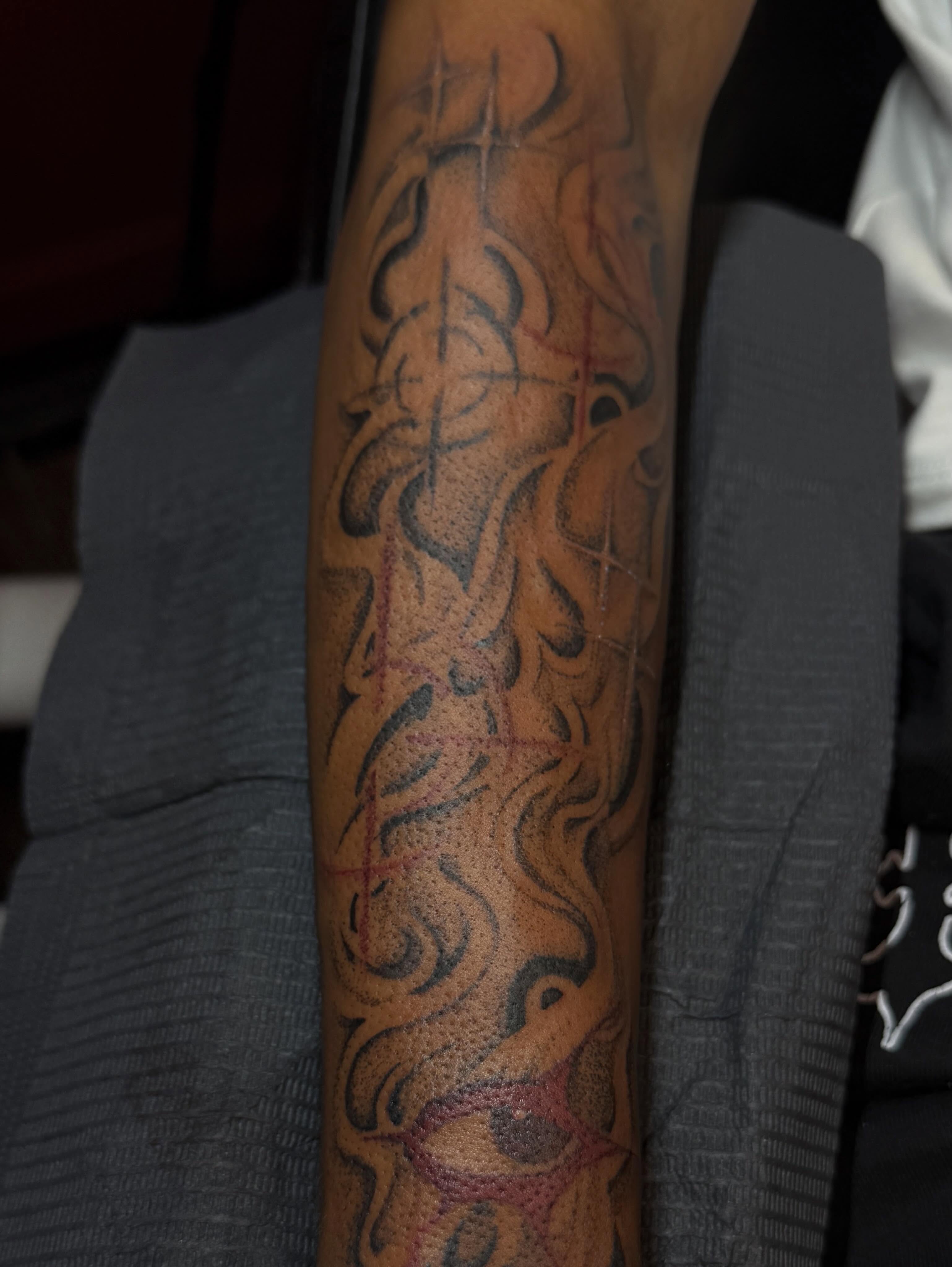 Scrollwork black and grey tattoo on the forearm by Destini