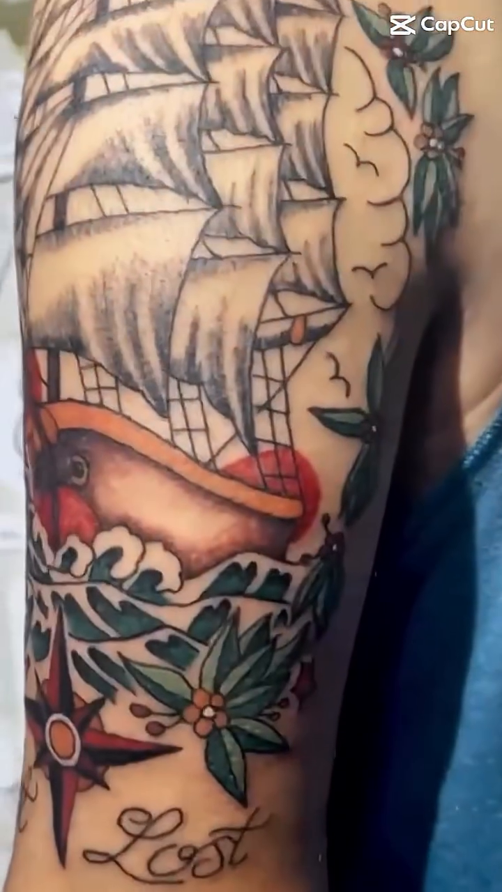 Sailing ship with compass and foliage Japanese tattoo on the forearm by Ink Napawong