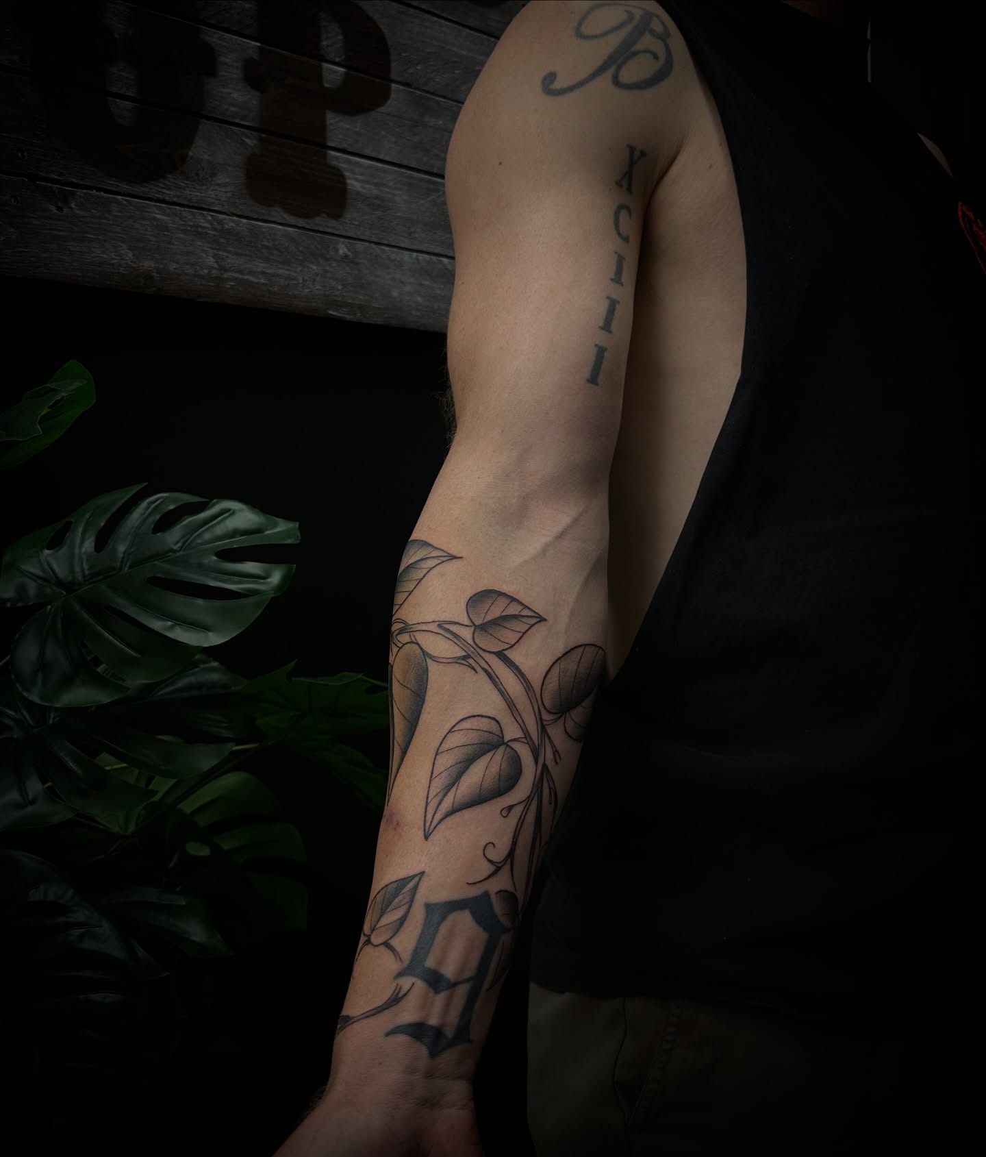 Leaf and vine black and grey tattoo on the forearm by Tyler Renfrow
