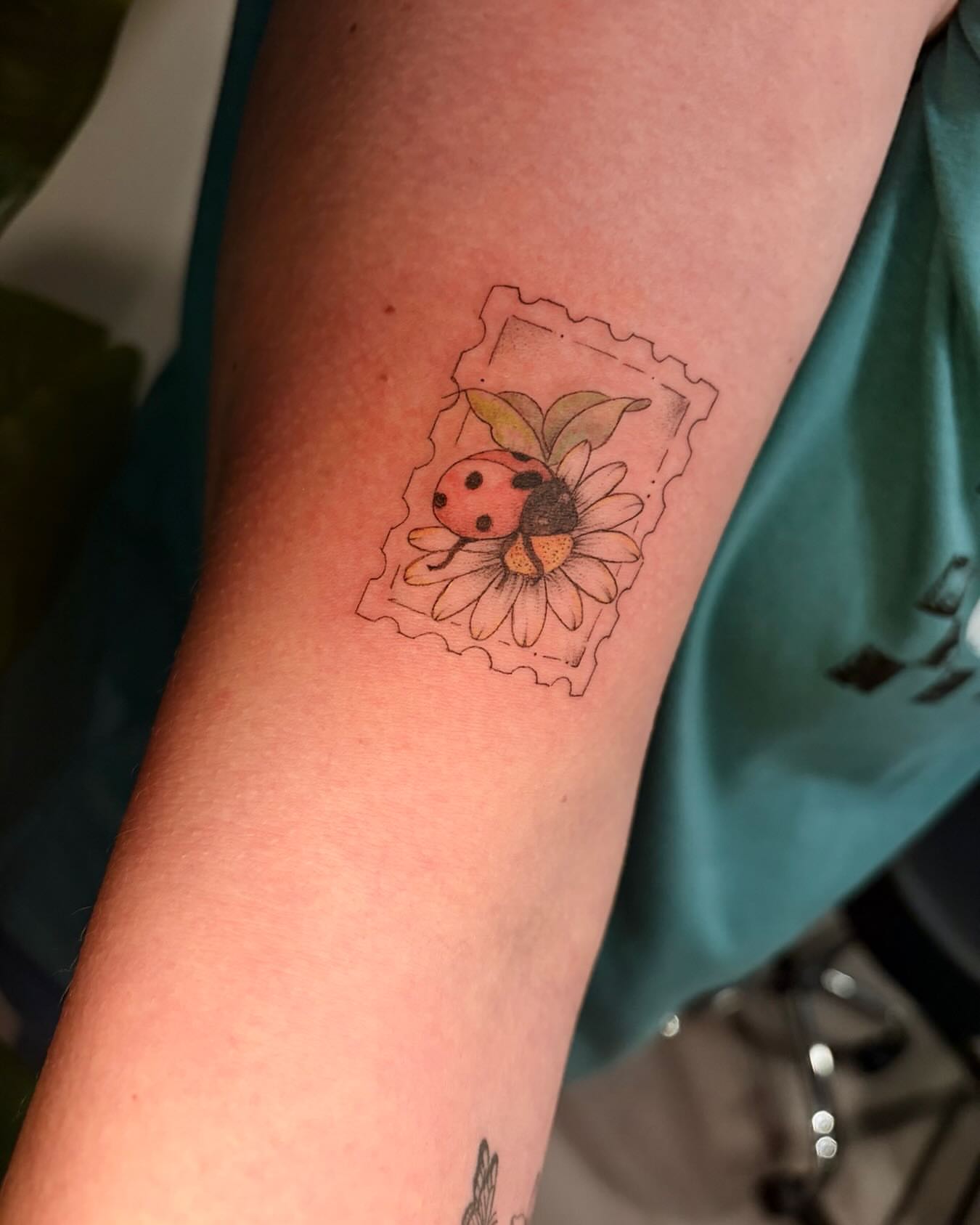 Ladybug and sunflower dotwork tattoo on the forearm by Ashley Pilgreen