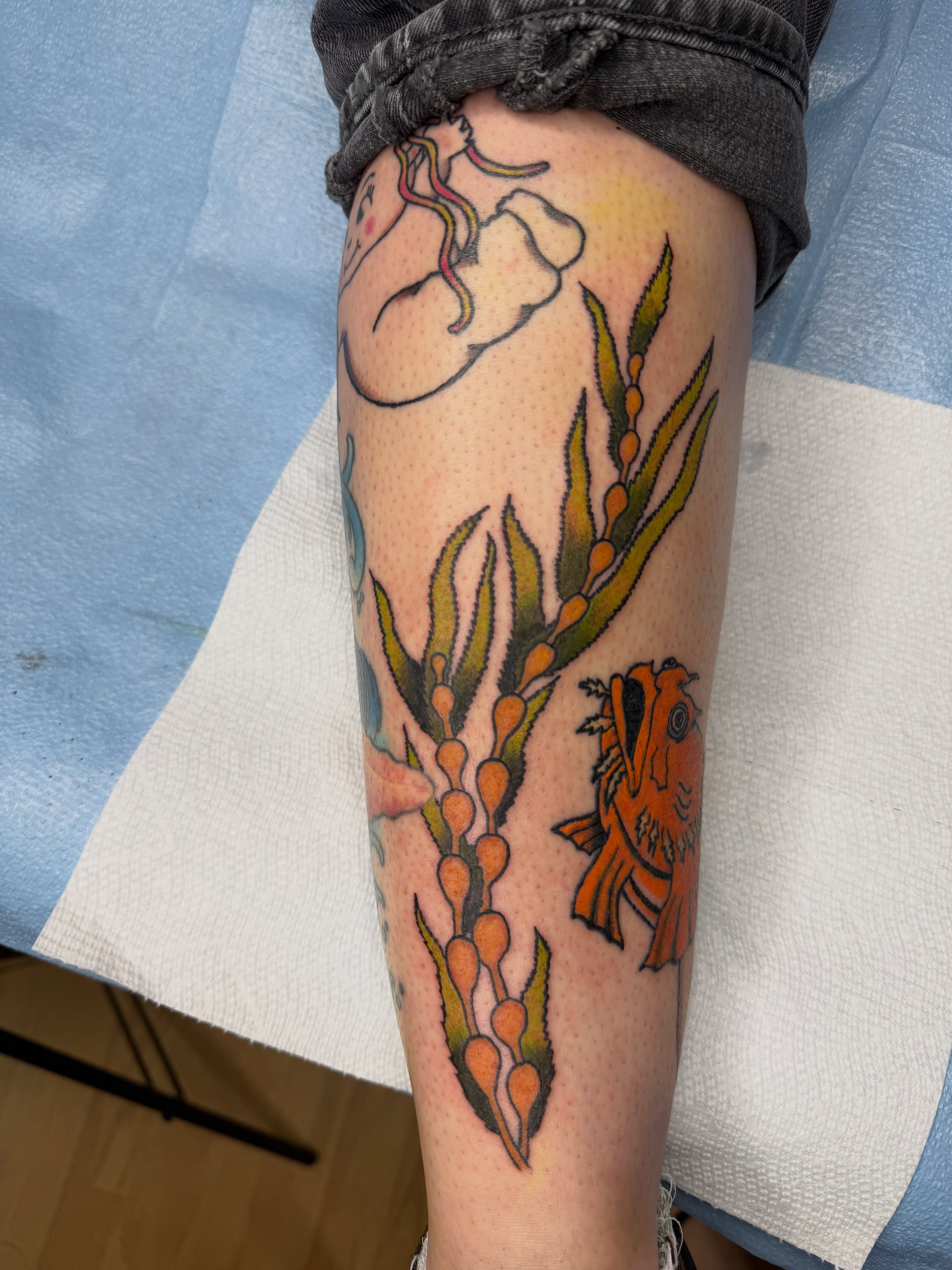 Seaweed and fish American traditional tattoo on the thigh by Giana Masso
