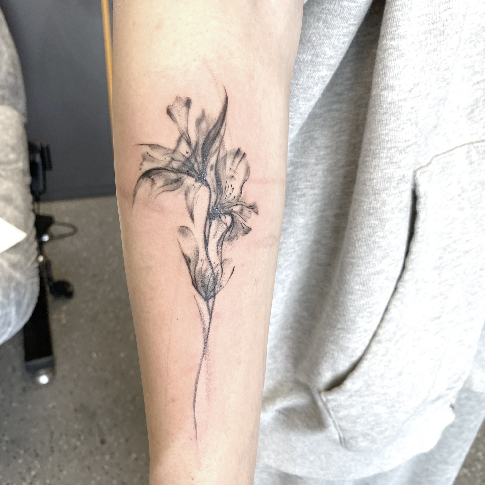 Lily black and grey tattoo on the forearm by R o s e