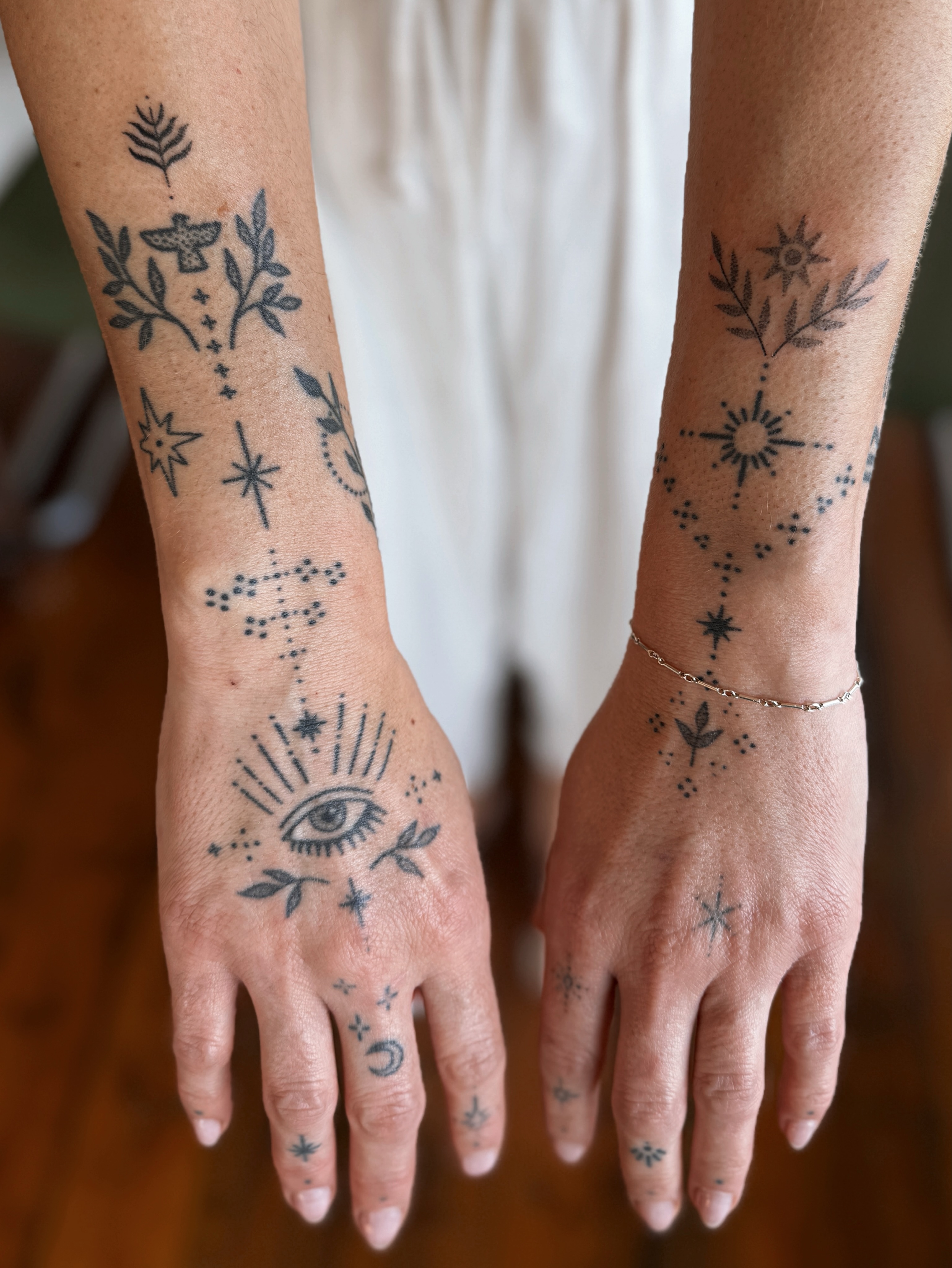 Eye and floral motifs dotwork tattoo on the forearm by Grace Wise - Handpoke Tattoos