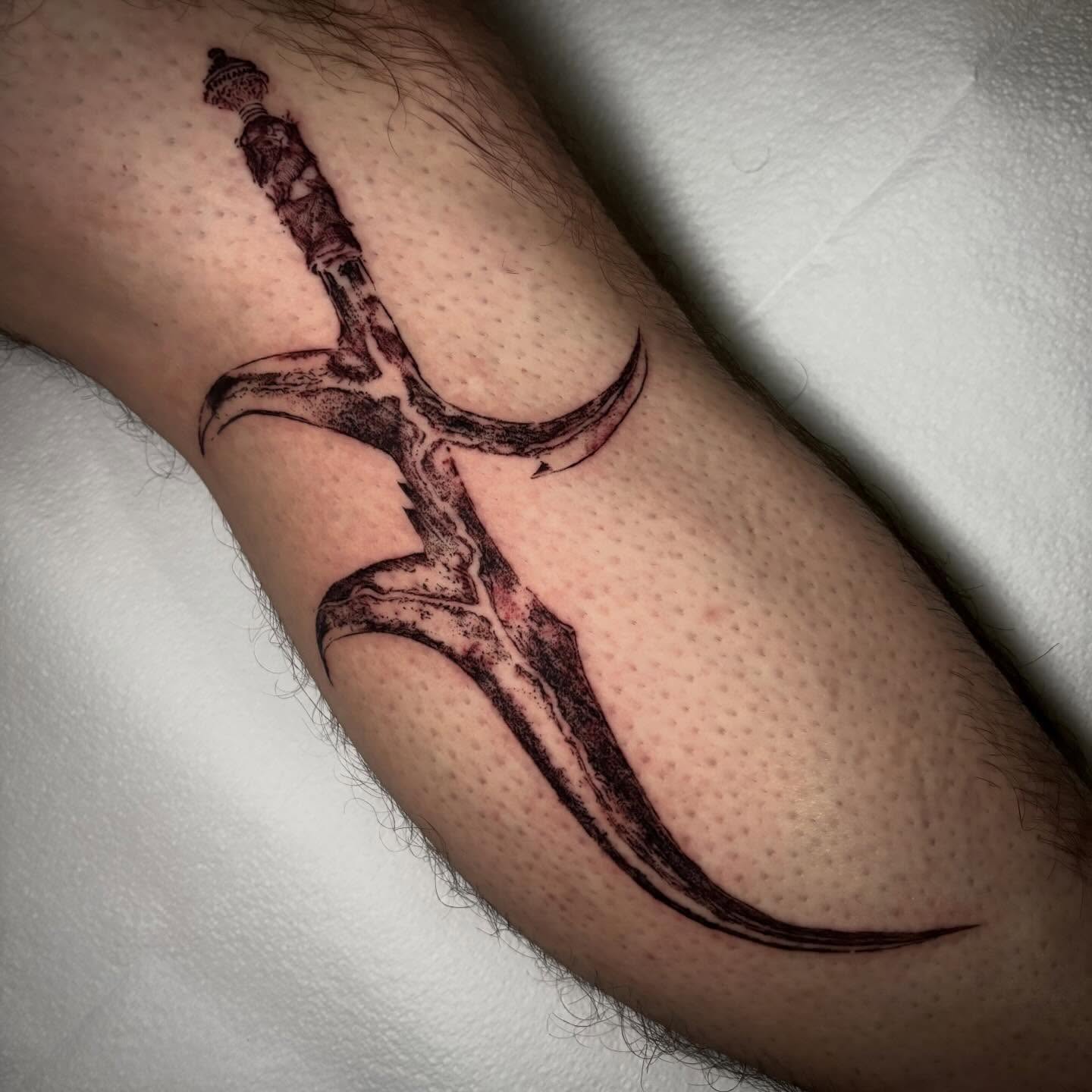 Sword black and grey tattoo on the forearm by unknown liquids tattoo