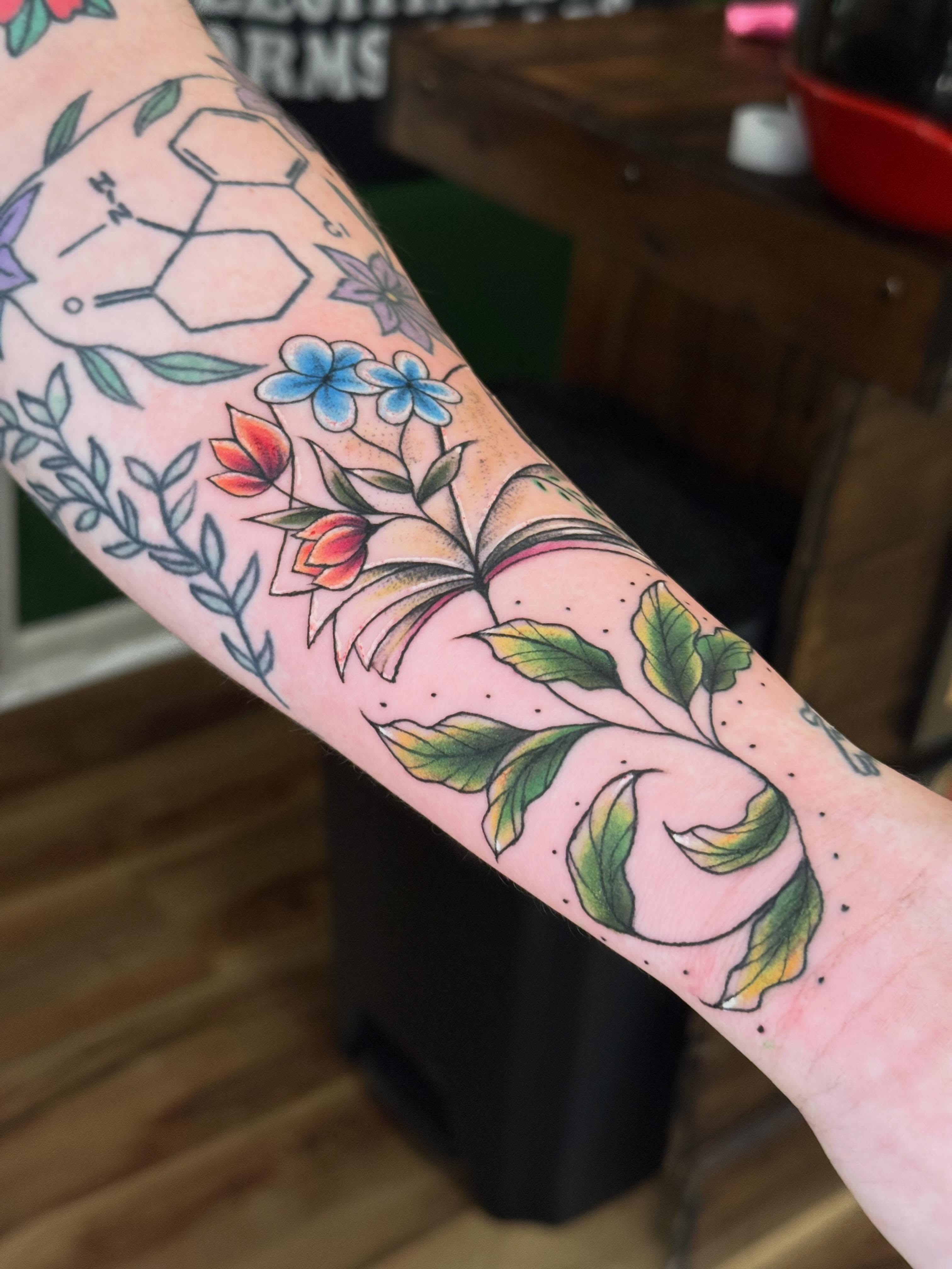 Floral arrangement American traditional tattoo on the forearm by Serenity Mullins