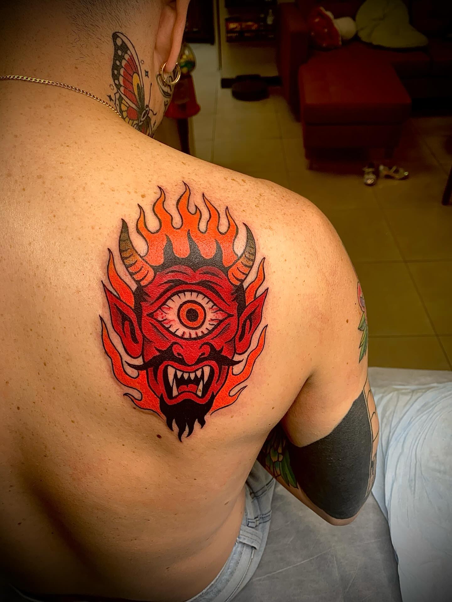 Demon face American traditional tattoo on the back by El Kapitan