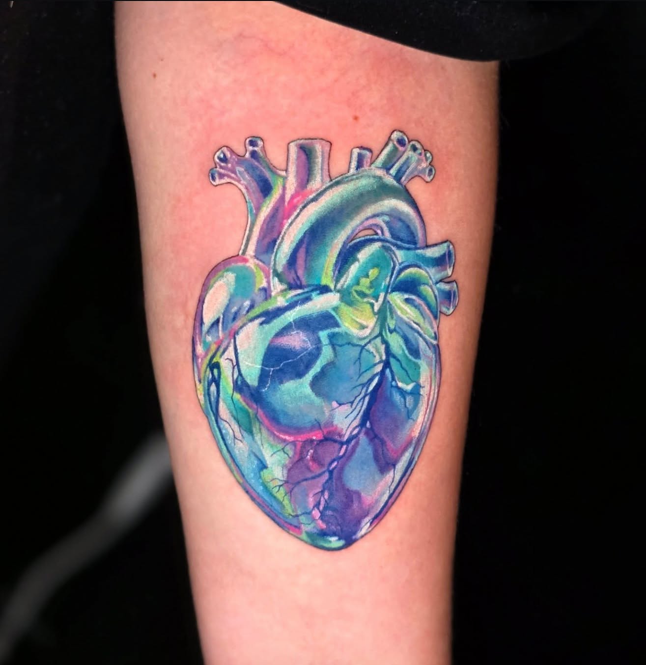 Anatomical heart watercolor tattoo on the forearm by Banana Cake
