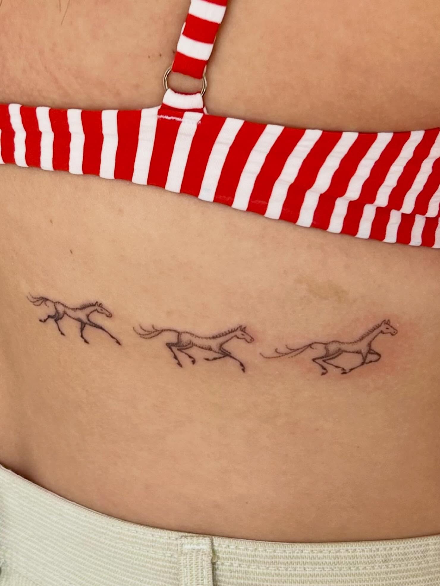Horses minimalist tattoo on the ribs by Nicolette