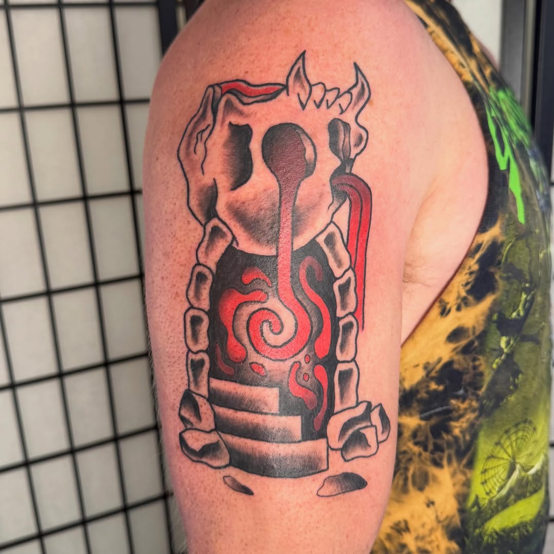 Candle black and grey tattoo on the upper arm by Zac Smith-Chevalier