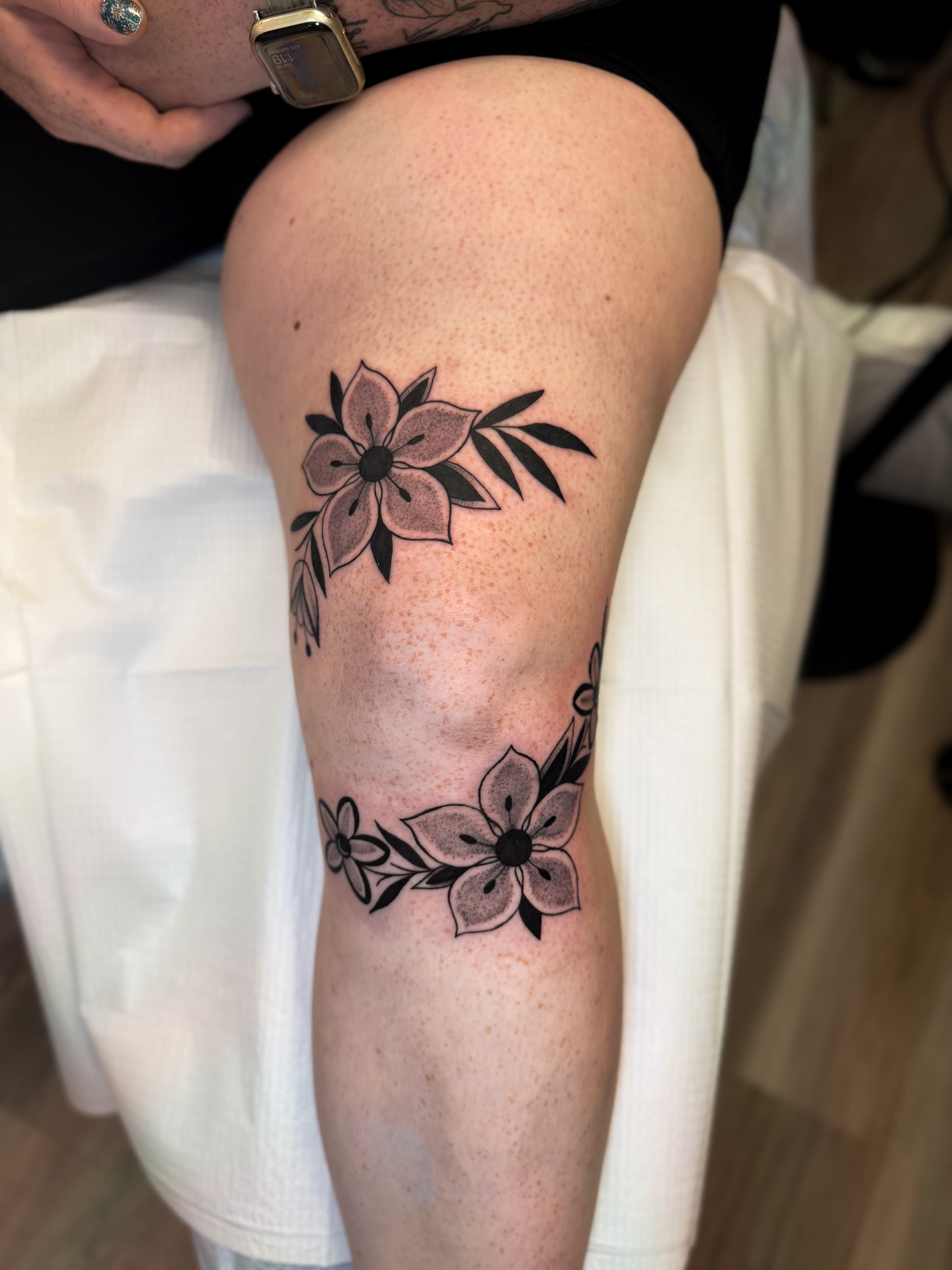 Flowers black and grey tattoo on the calf by McKenna