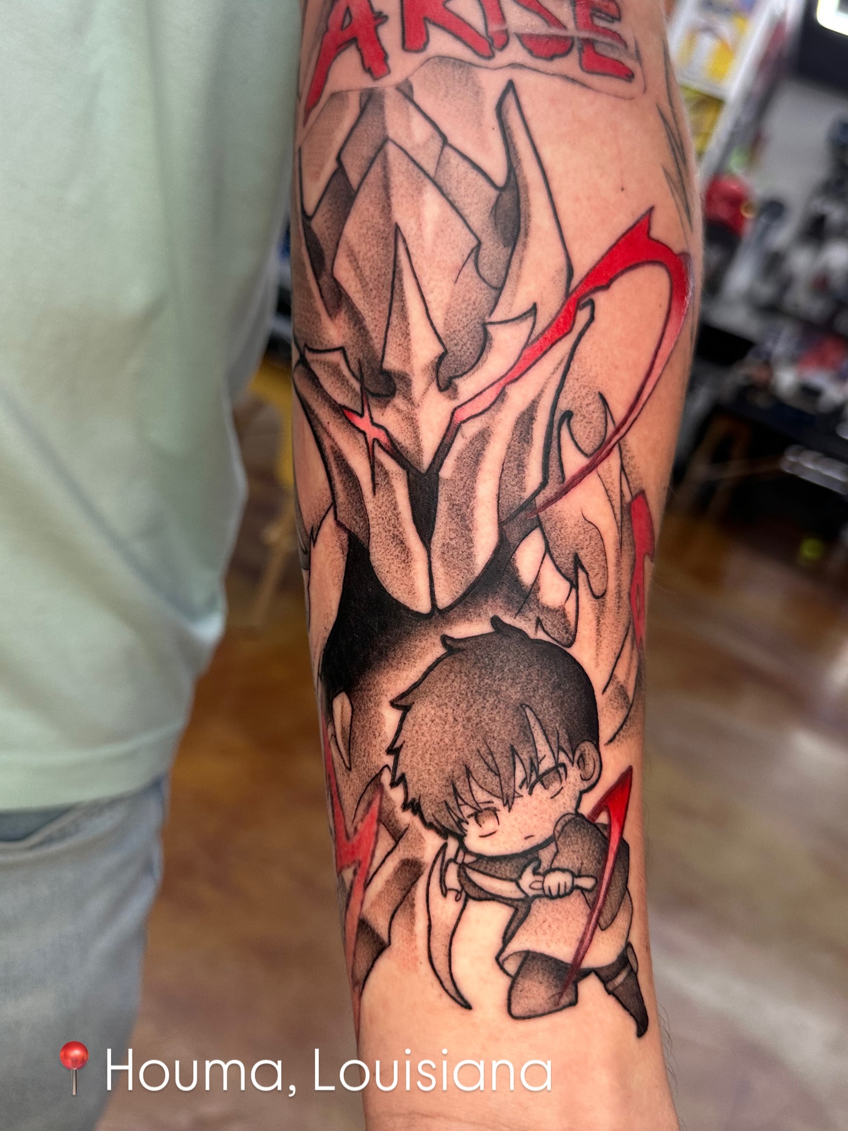 Anime character and sword anime tattoo on the forearm by Trent Hebert