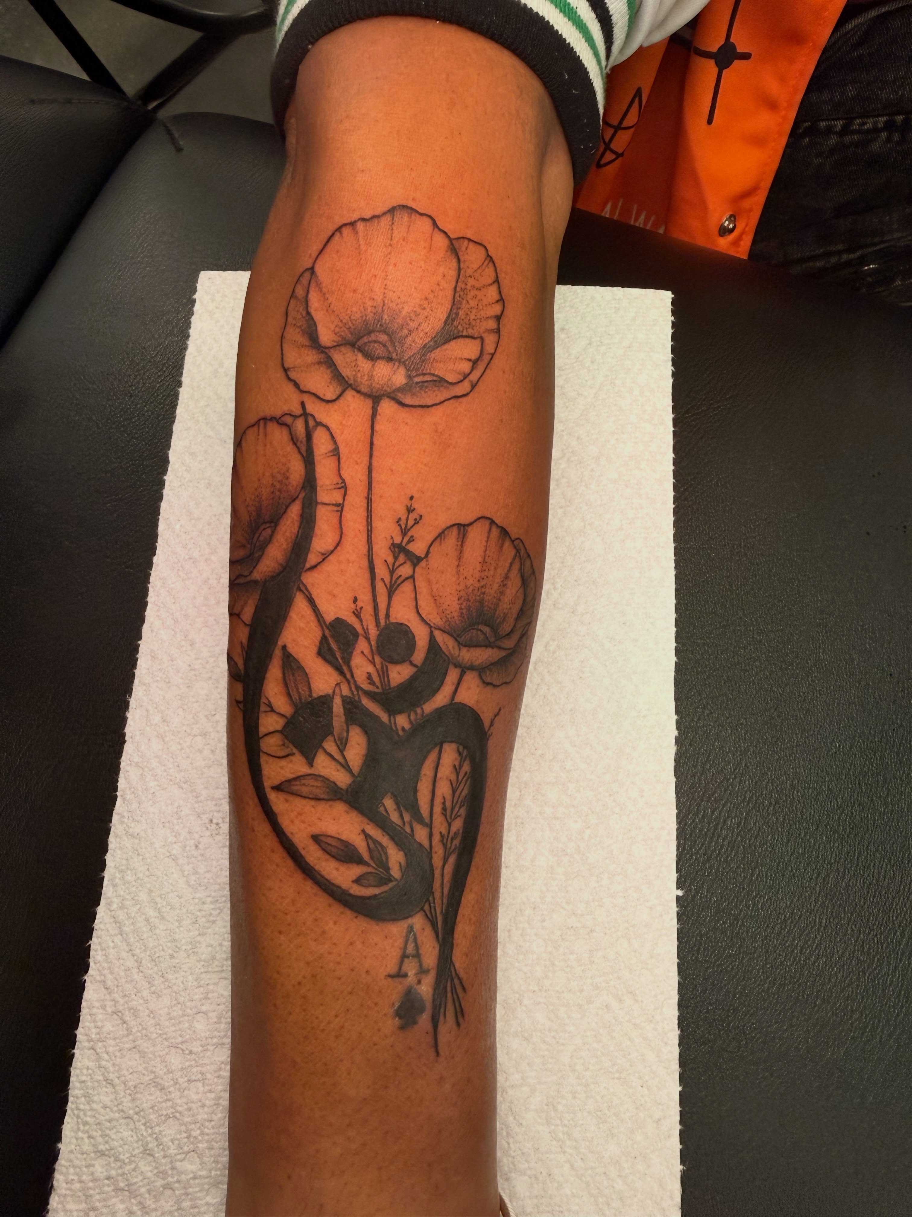 Poppy flowers and snake realism tattoo on the forearm by Butta