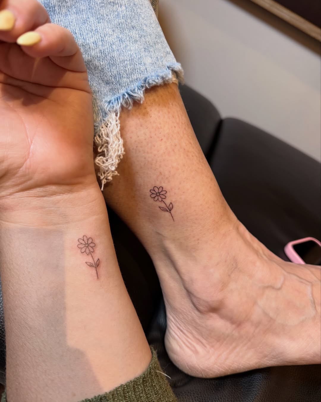 Flower fine line tattoo on the foot by Fineline Tattoo