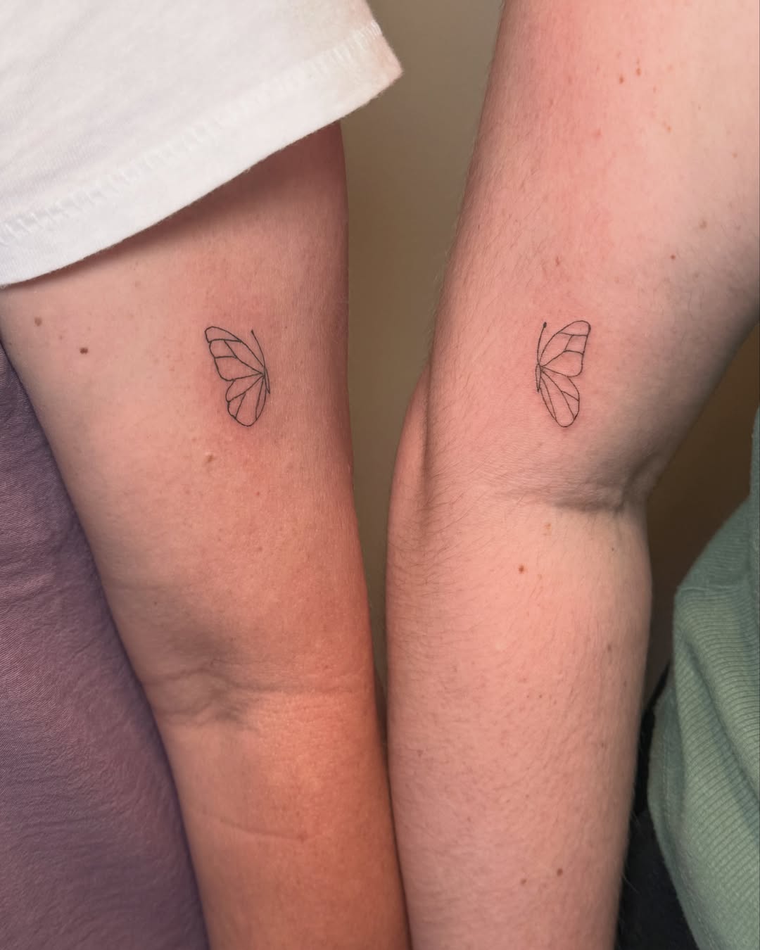 Butterfly minimalist tattoo on the forearm by Fineline Tattoo