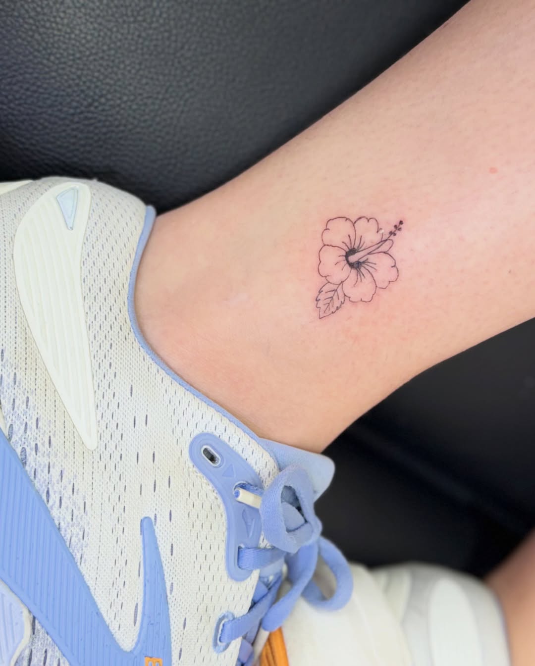 Hibiscus flower fine line tattoo on the forearm by Fineline Tattoo