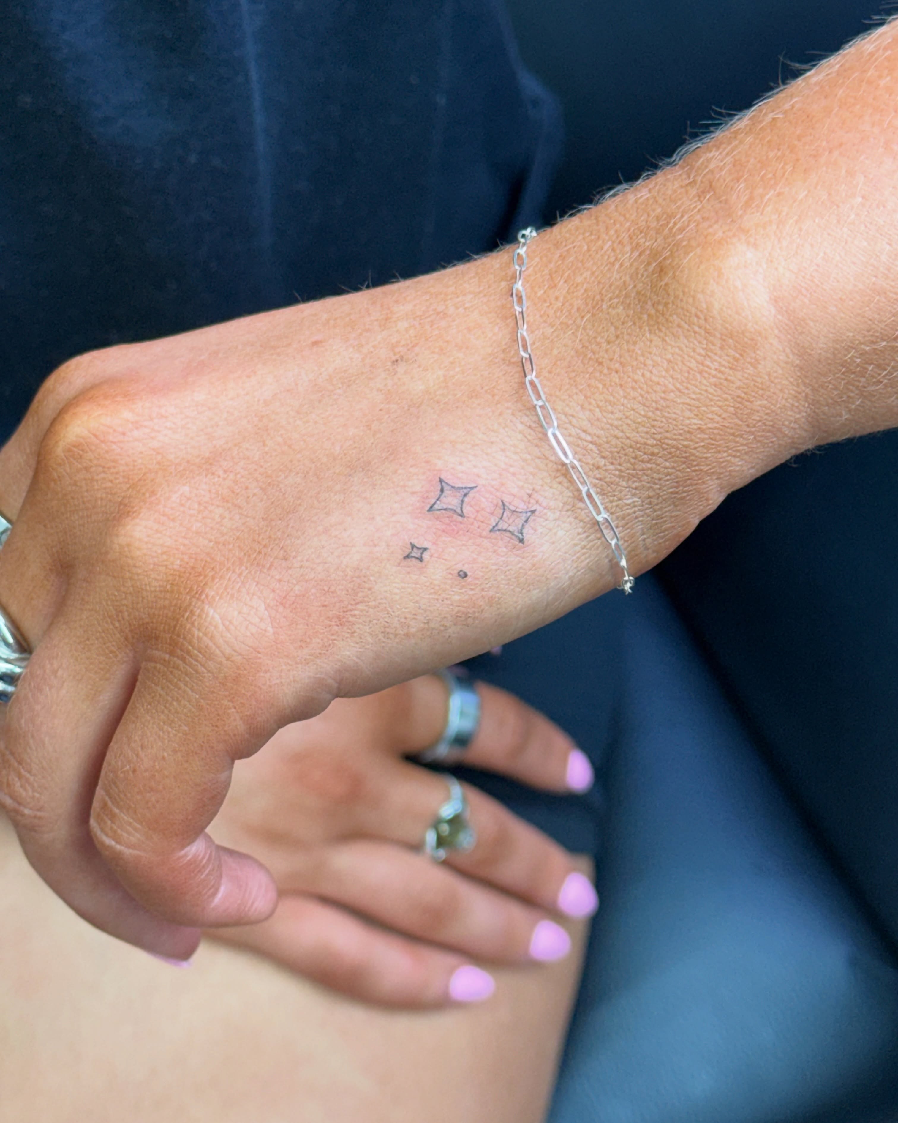 Stars dotwork tattoo on the forearm by Fineline Tattoo