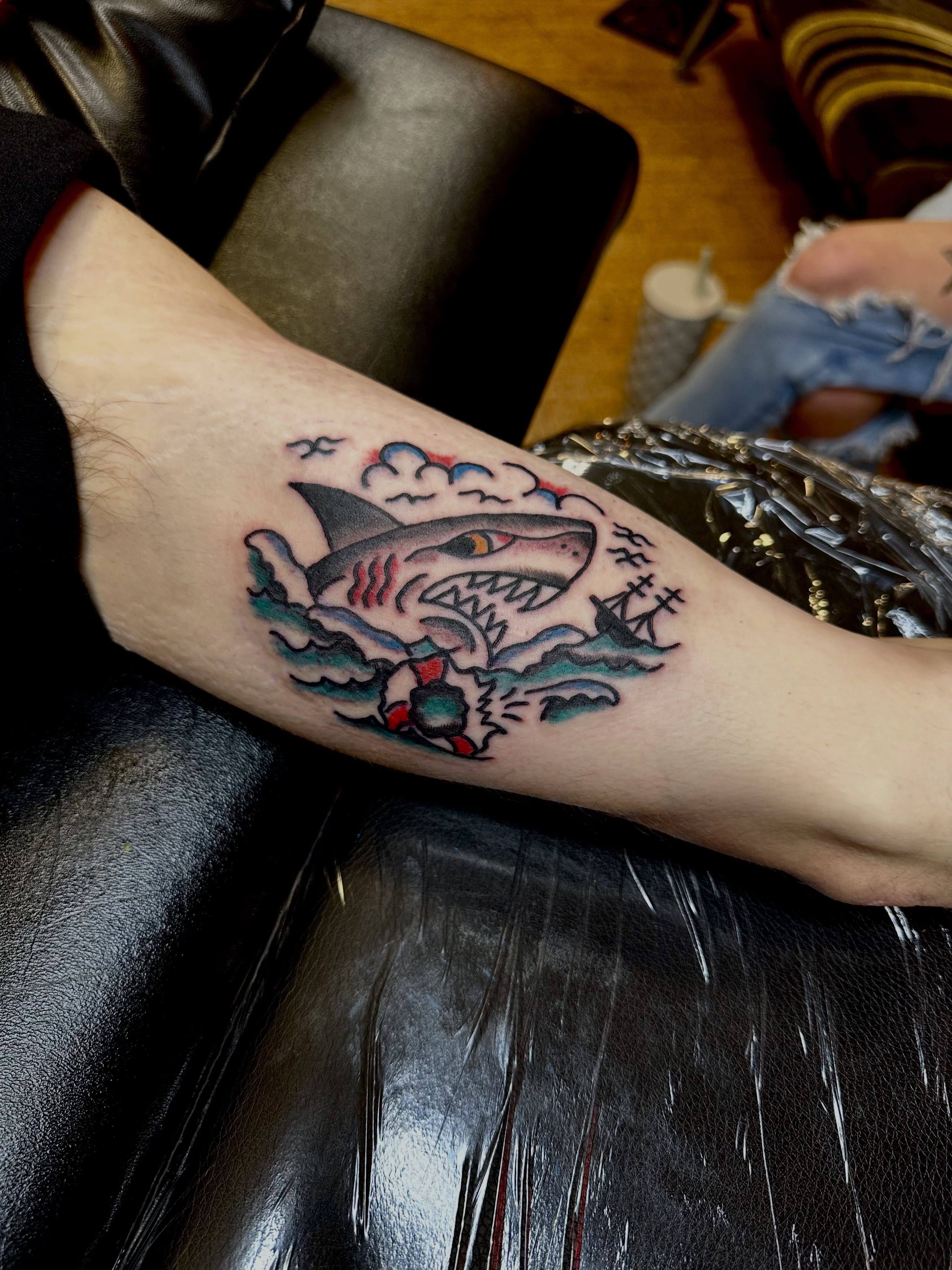 Shark attack scene American traditional tattoo on the forearm by teddy, Portland, Oregon