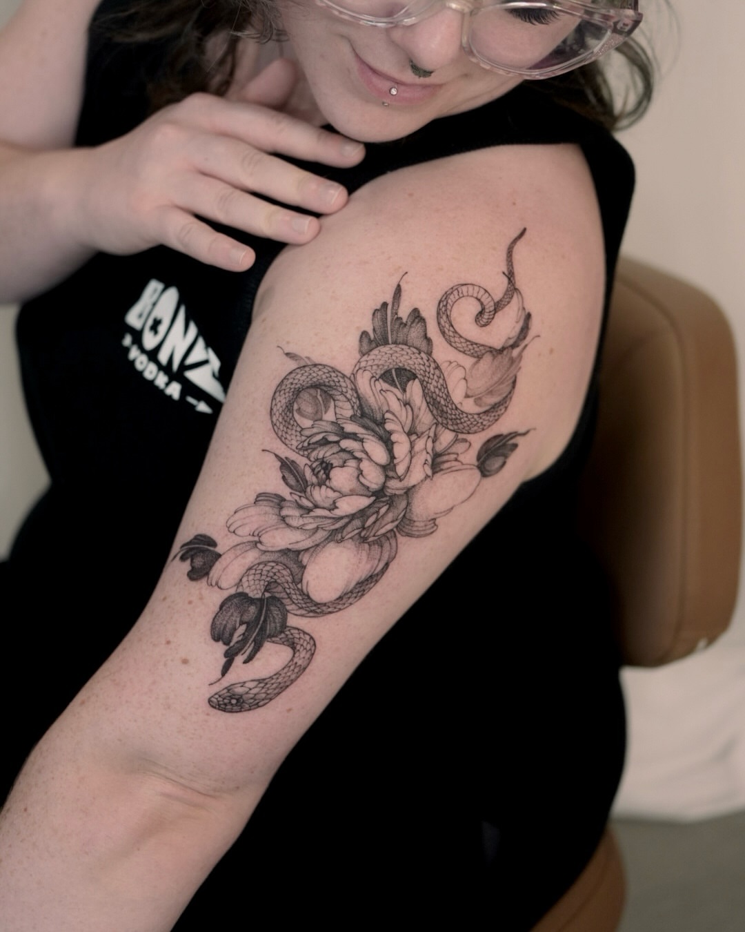 Snake and peony black and grey tattoo on the forearm by Joy, Gold Coast, Queensland