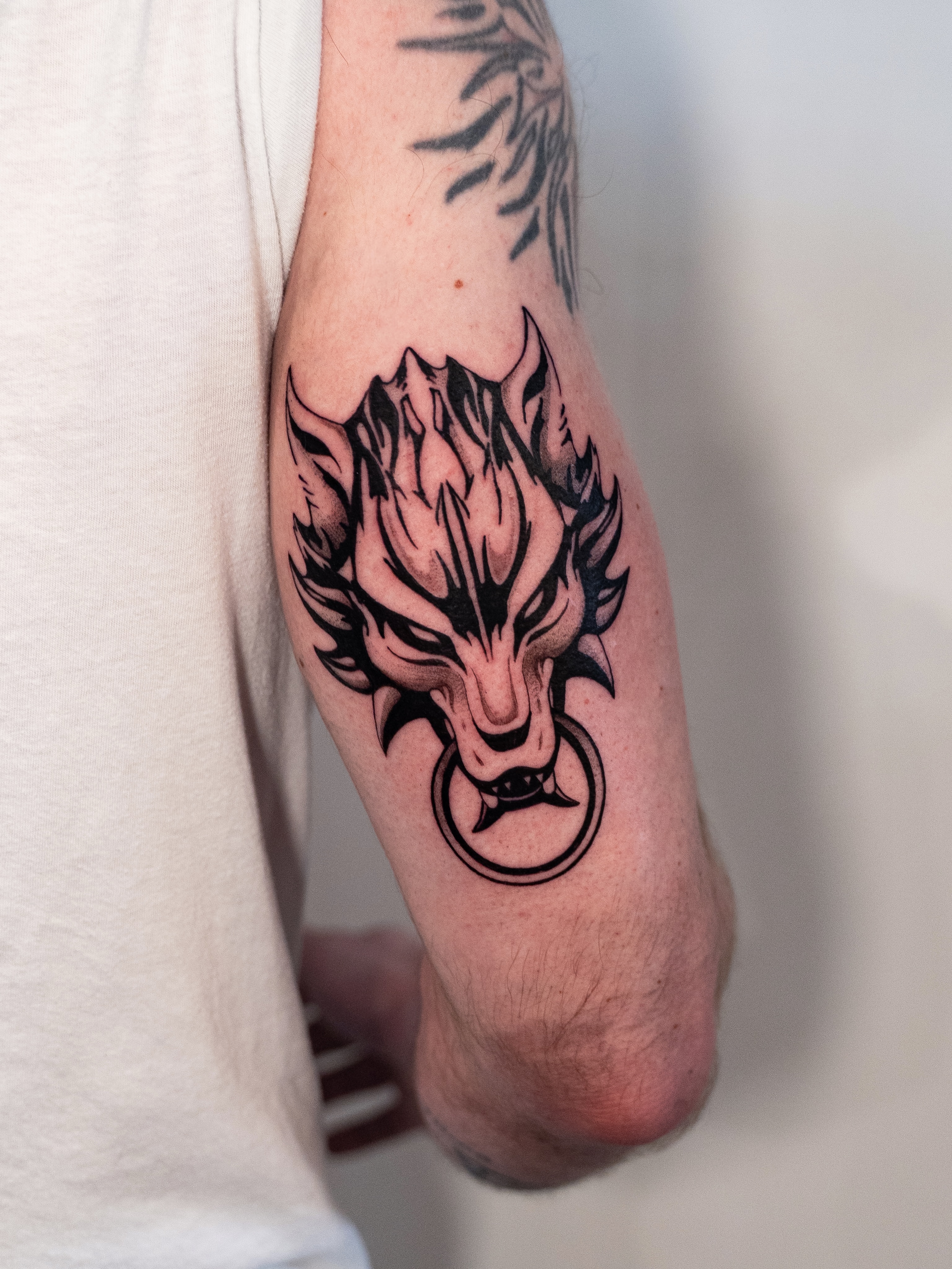 Wolf head black and grey tattoo on the forearm by Kalin, Seattle, Washington