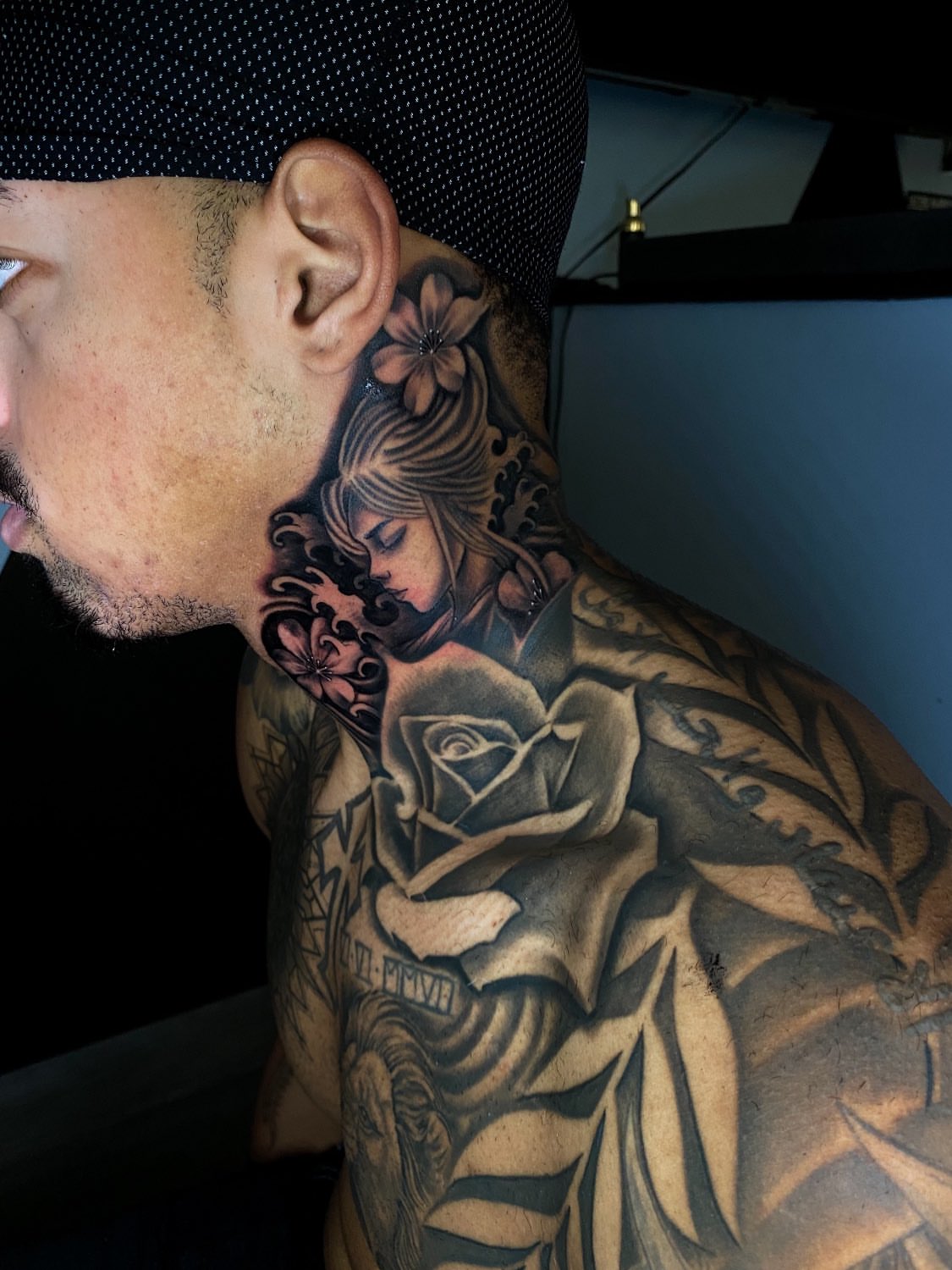 Woman with rose realism tattoo on the neck by Kelan Mckenna