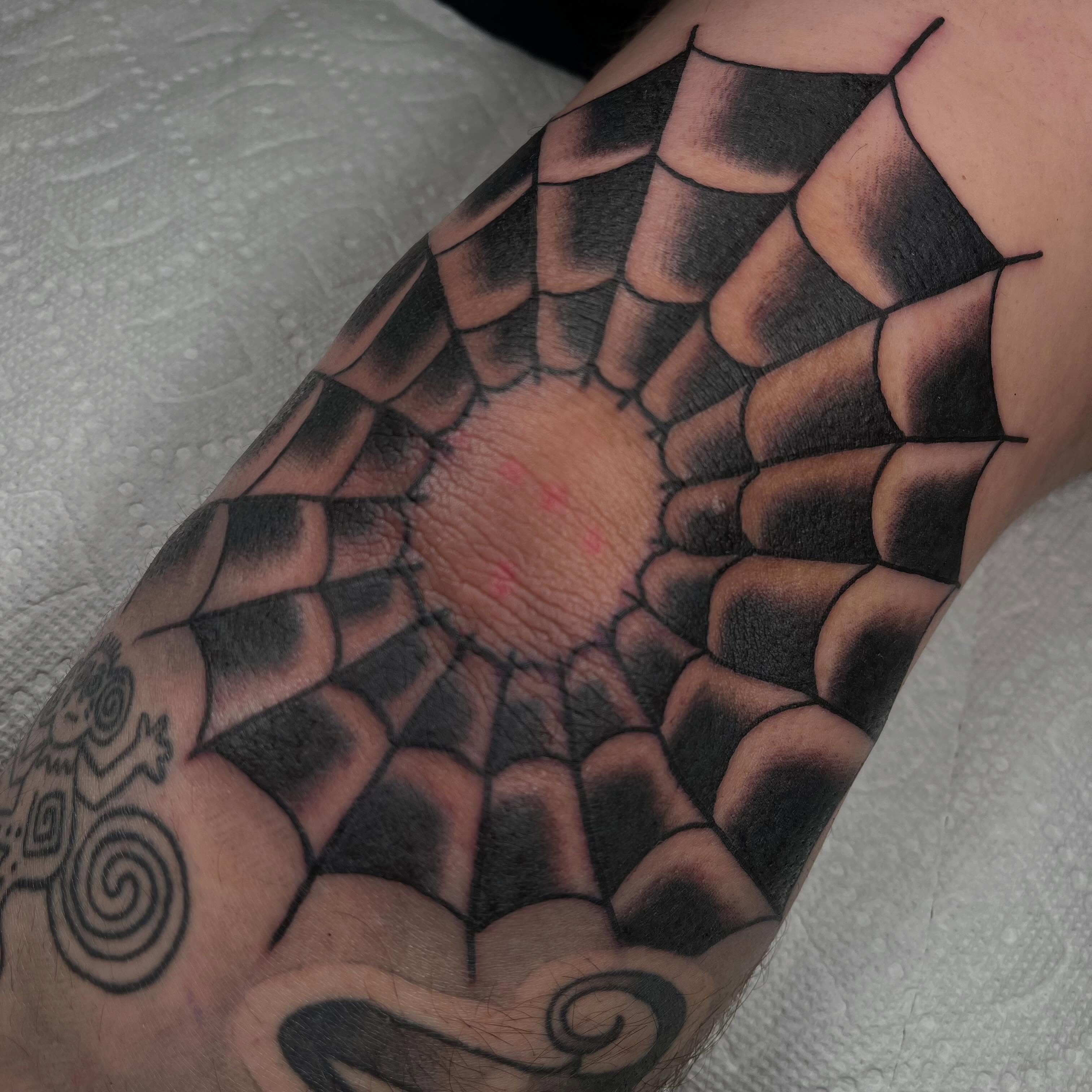 Spiderweb black and grey tattoo on the forearm by Jennifer Medrano