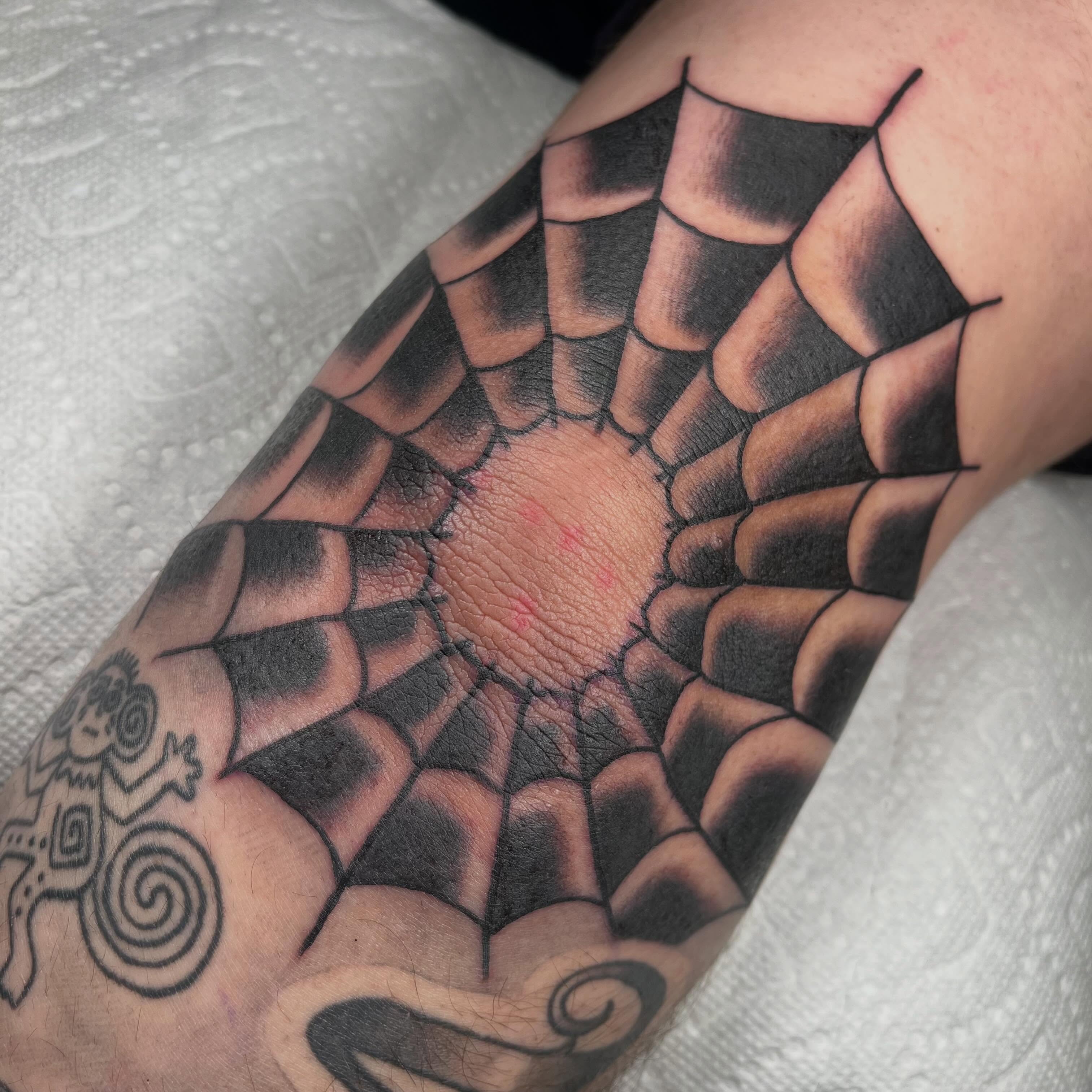 Spiderweb geometric tattoo on the forearm by Jennifer Medrano