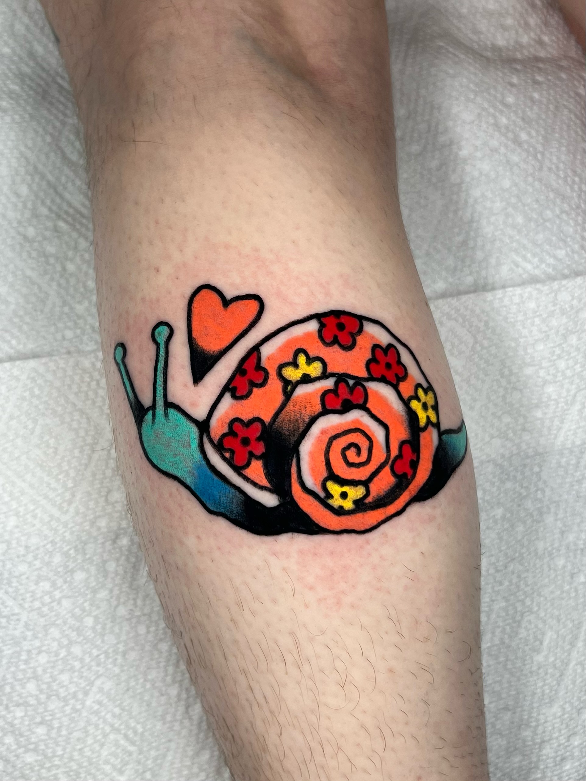 Snail new school tattoo on the forearm by Sierra Mack