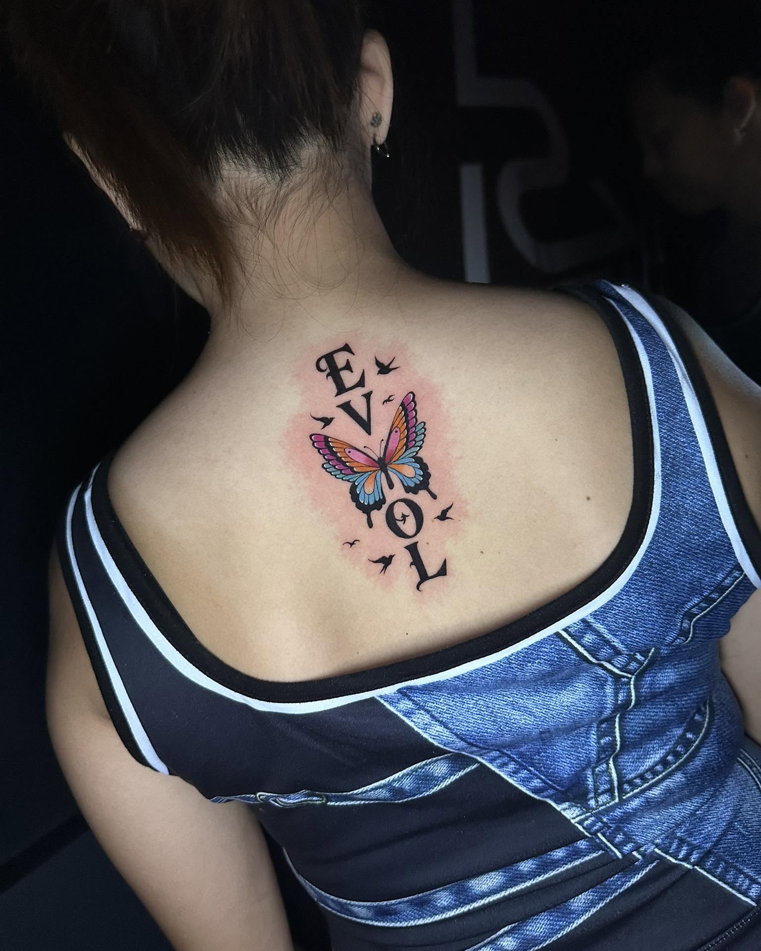 Butterfly and text new school tattoo on the back by Stephen Degracia