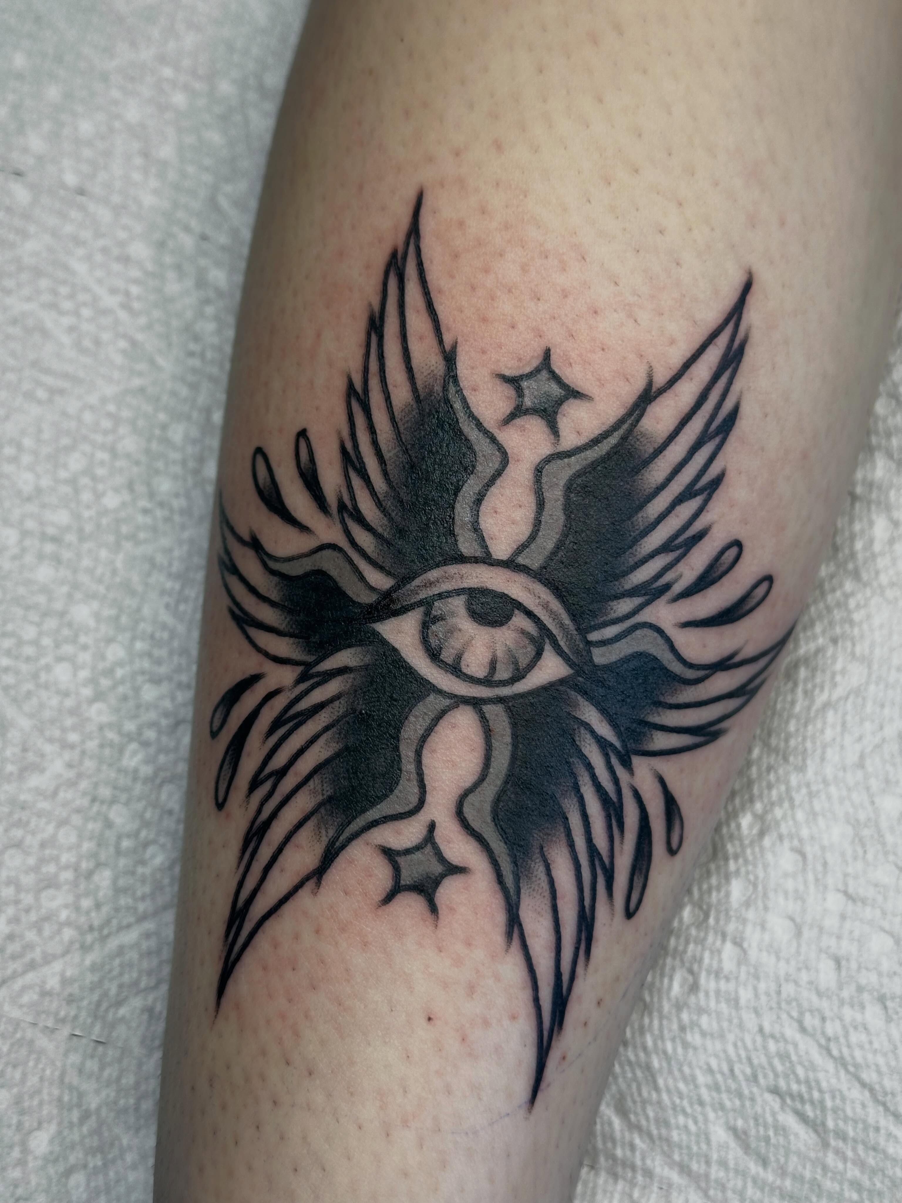 Eye with wings black and grey tattoo on the forearm by Elisha B🦷