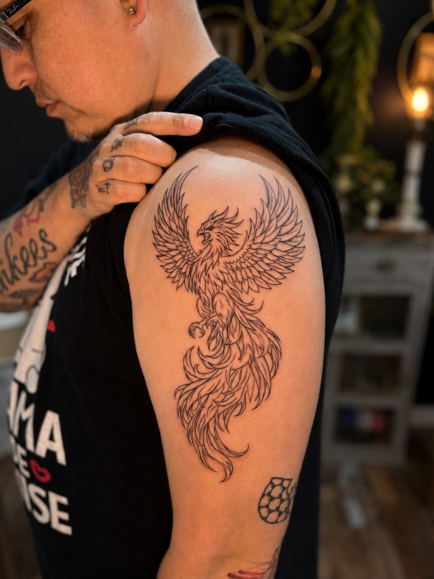 Phoenix fine line tattoo on the shoulder by JAmy Winters