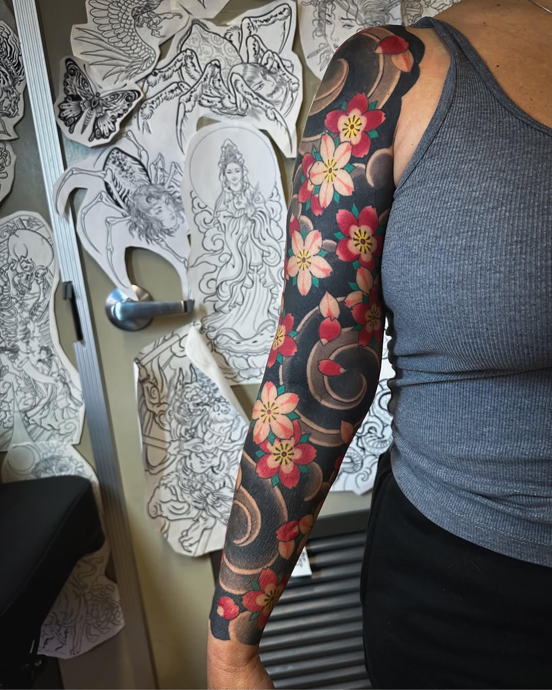 Cherry blossoms and swirls japanese irezumi tattoo on the upper arm by Colin Kenji Baker, San Jose, California