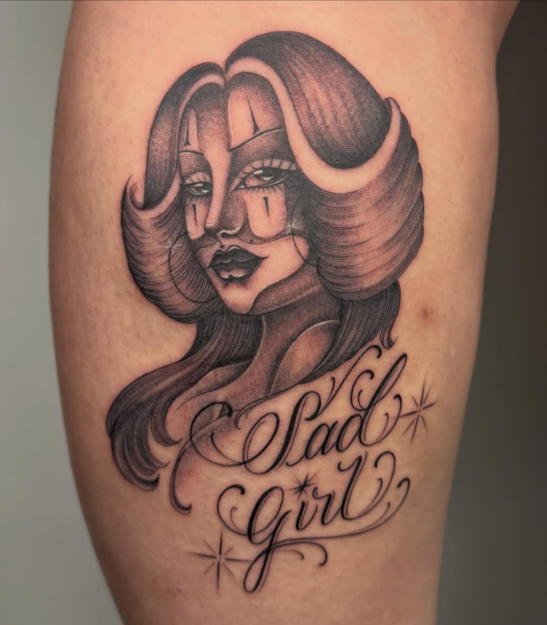 Woman with horns black and grey tattoo on the thigh by H e I D I