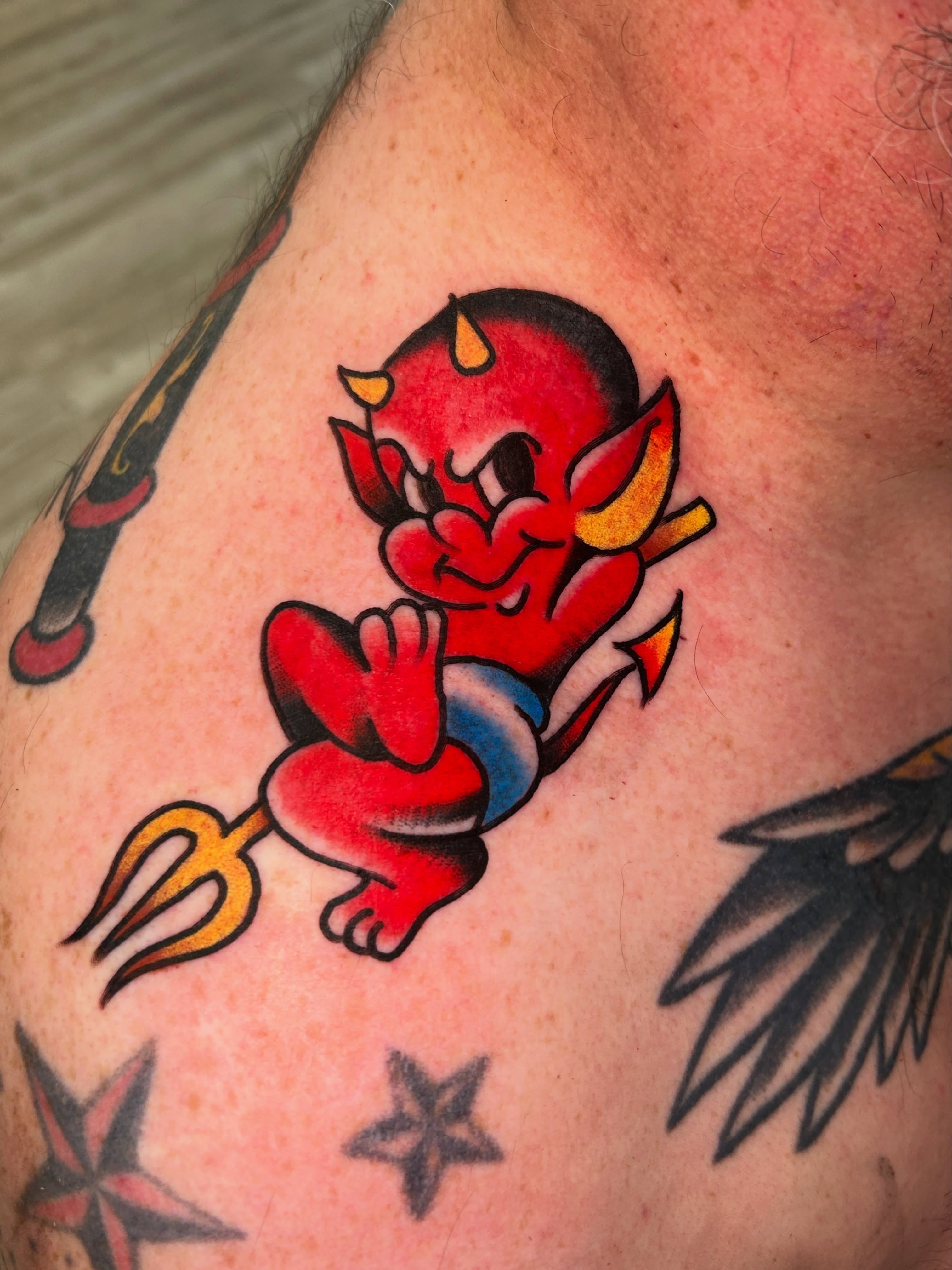 Red devil American traditional tattoo on the shoulder by Eric Caudill, Indianapolis, Indiana