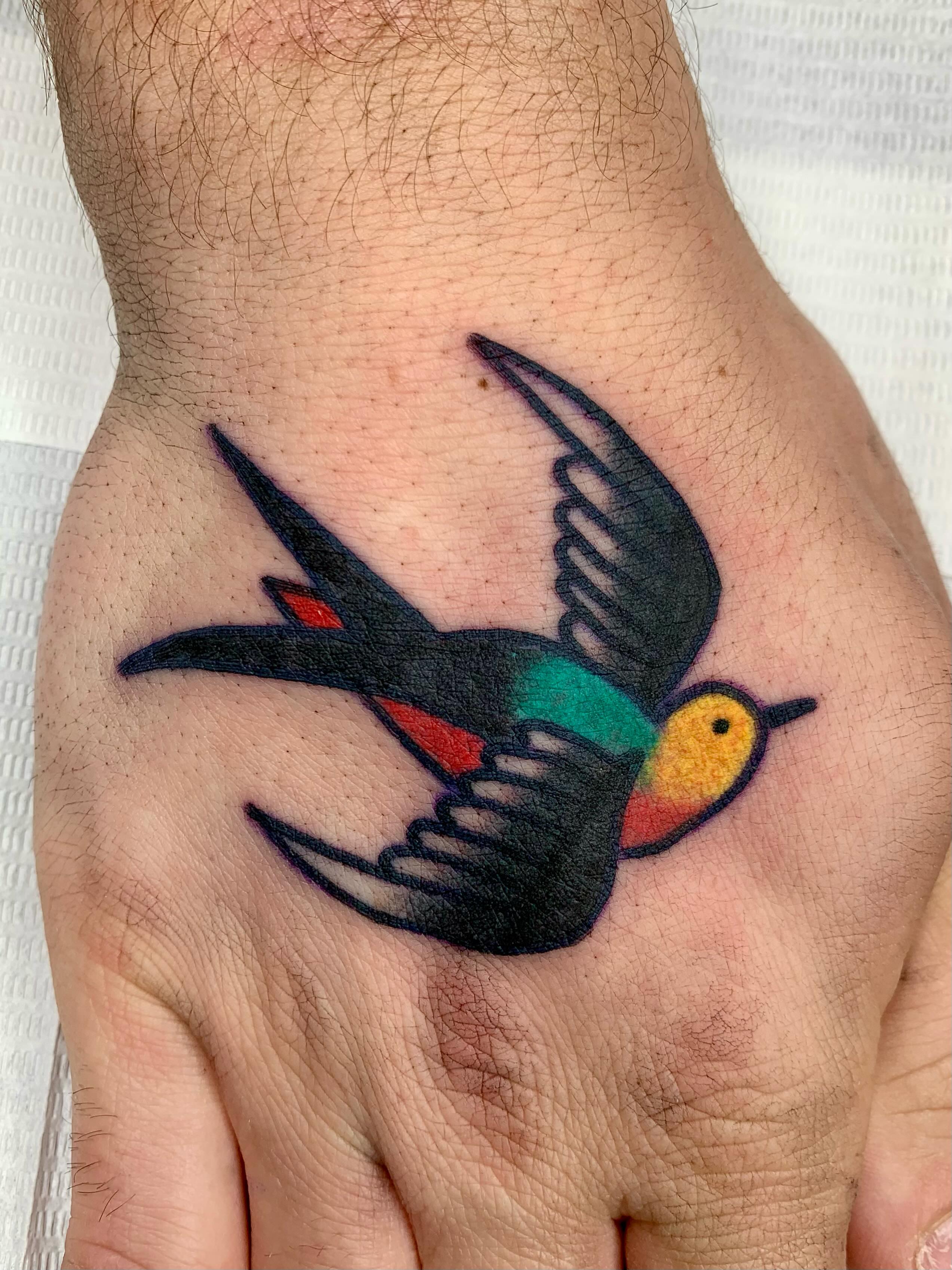 Swallow American traditional tattoo on the hand by Keegan Bergen