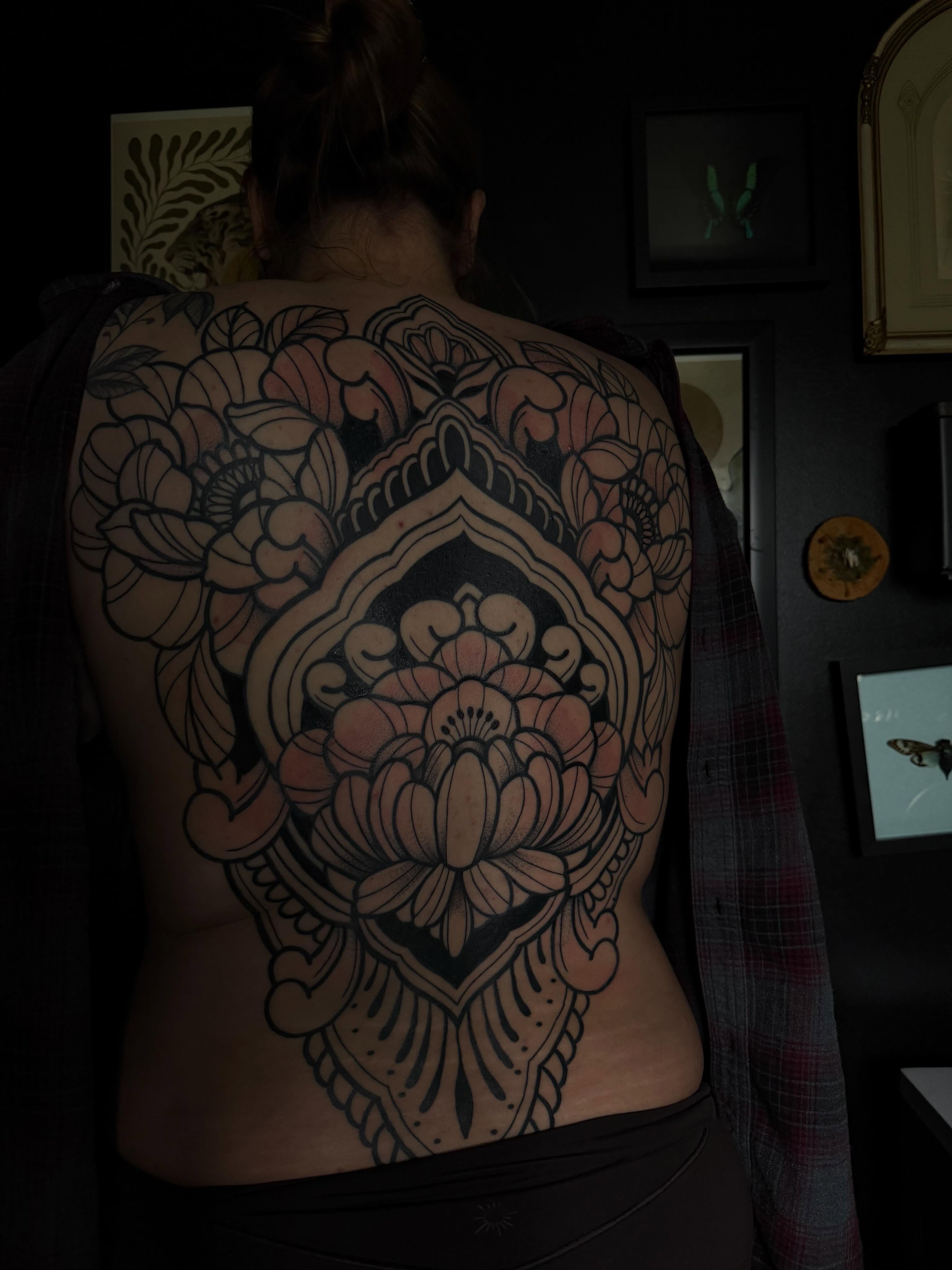 Lotus flower ornamental tattoo on the back by Allison