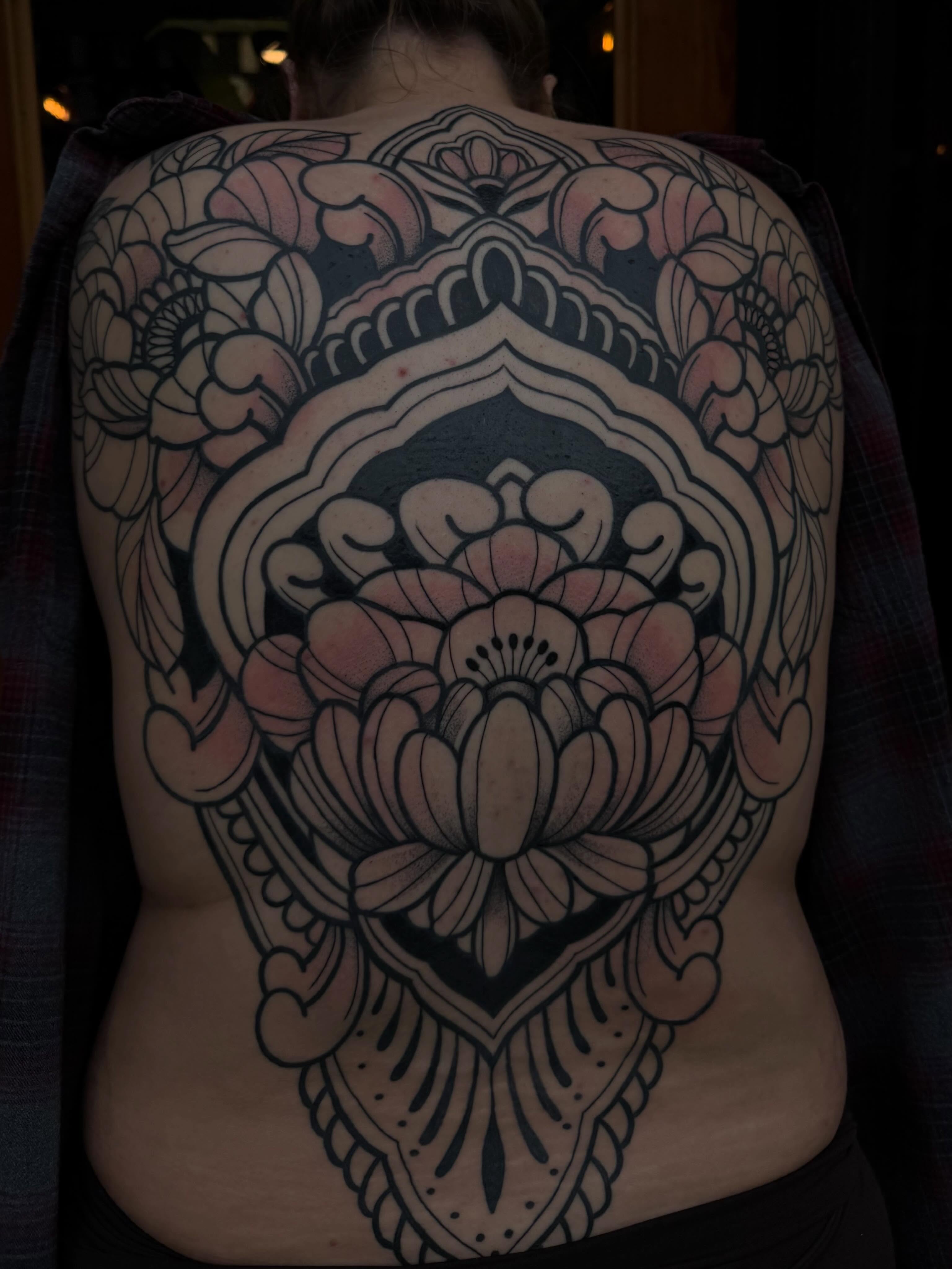 Lotus flower American traditional tattoo on the back by Allison