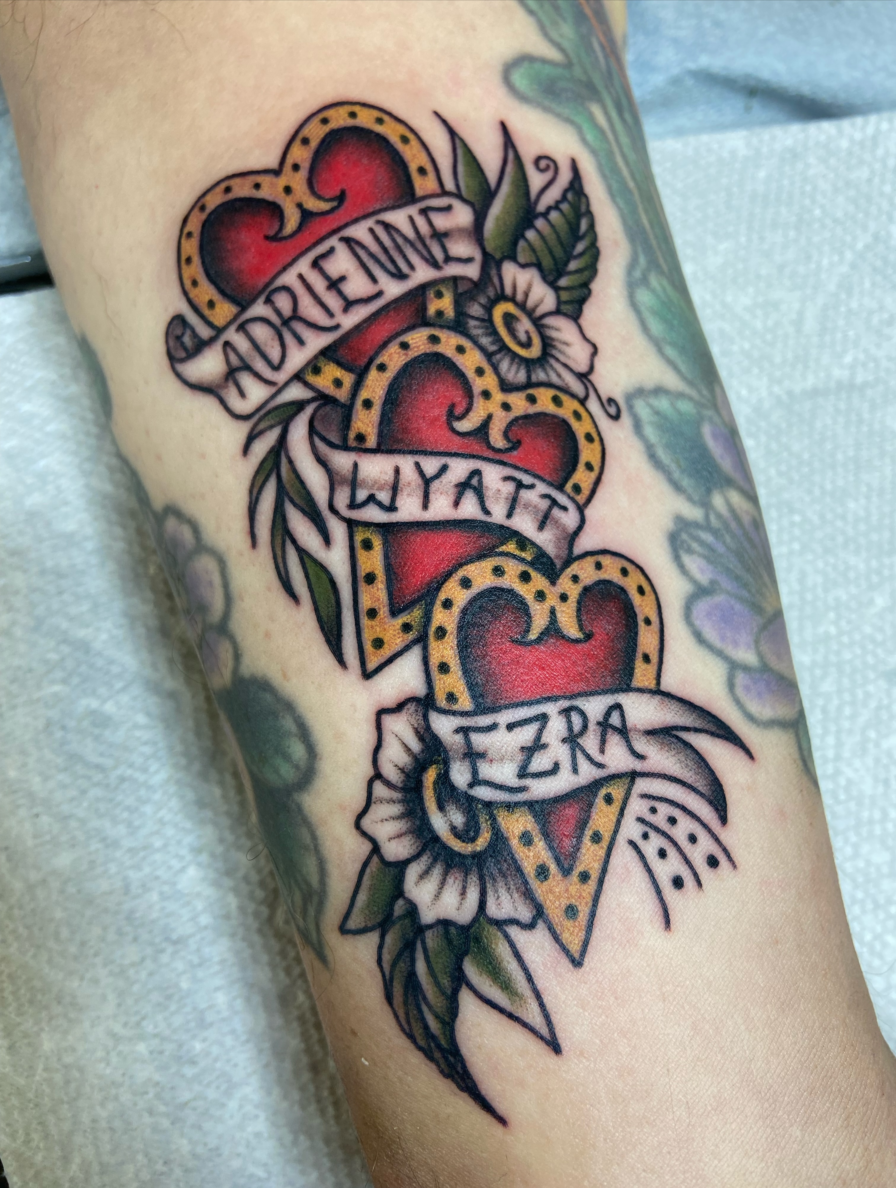 Heart and names American traditional tattoo on the forearm by R y a n S m i t h