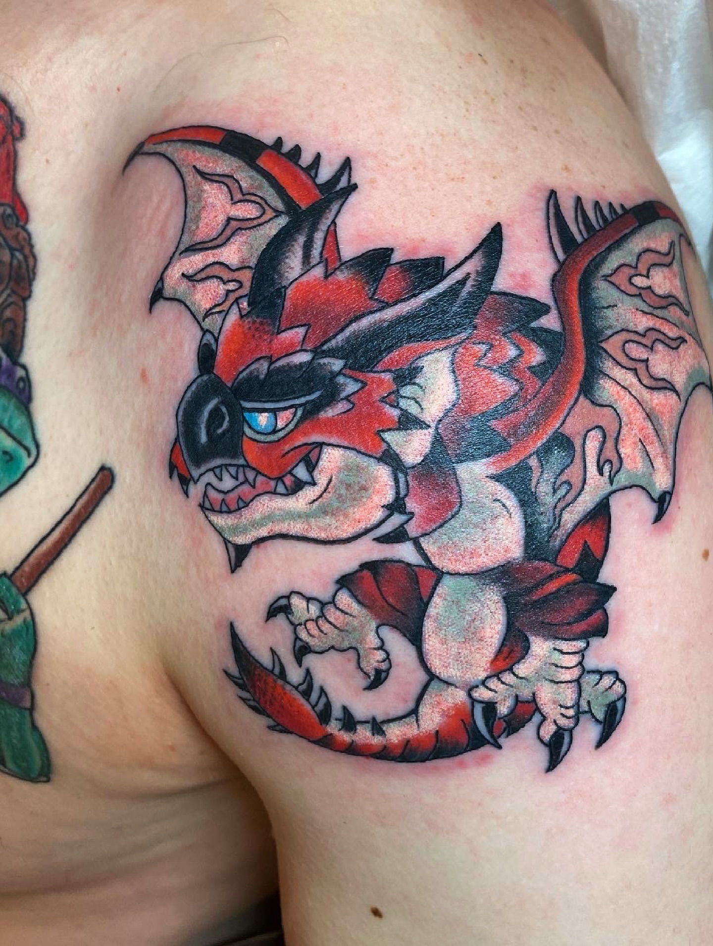 Dragon American traditional tattoo on the shoulder by Aidan Monahan Tattoo