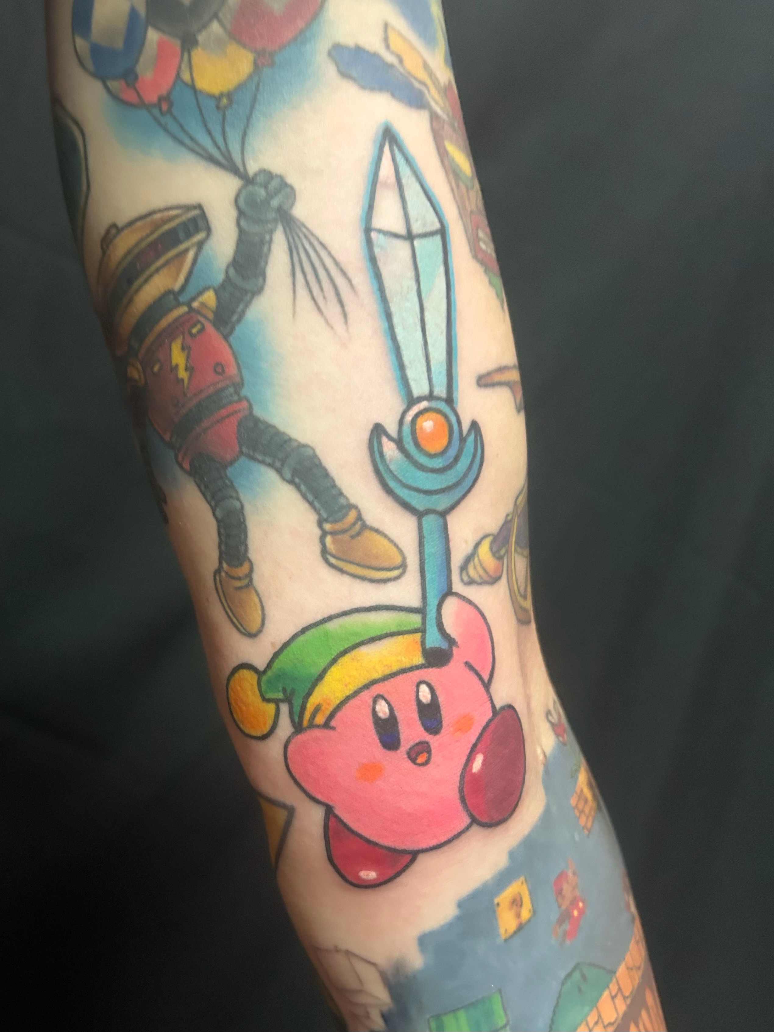 Kirby and Balloon Man anime tattoo on the forearm by Ollie