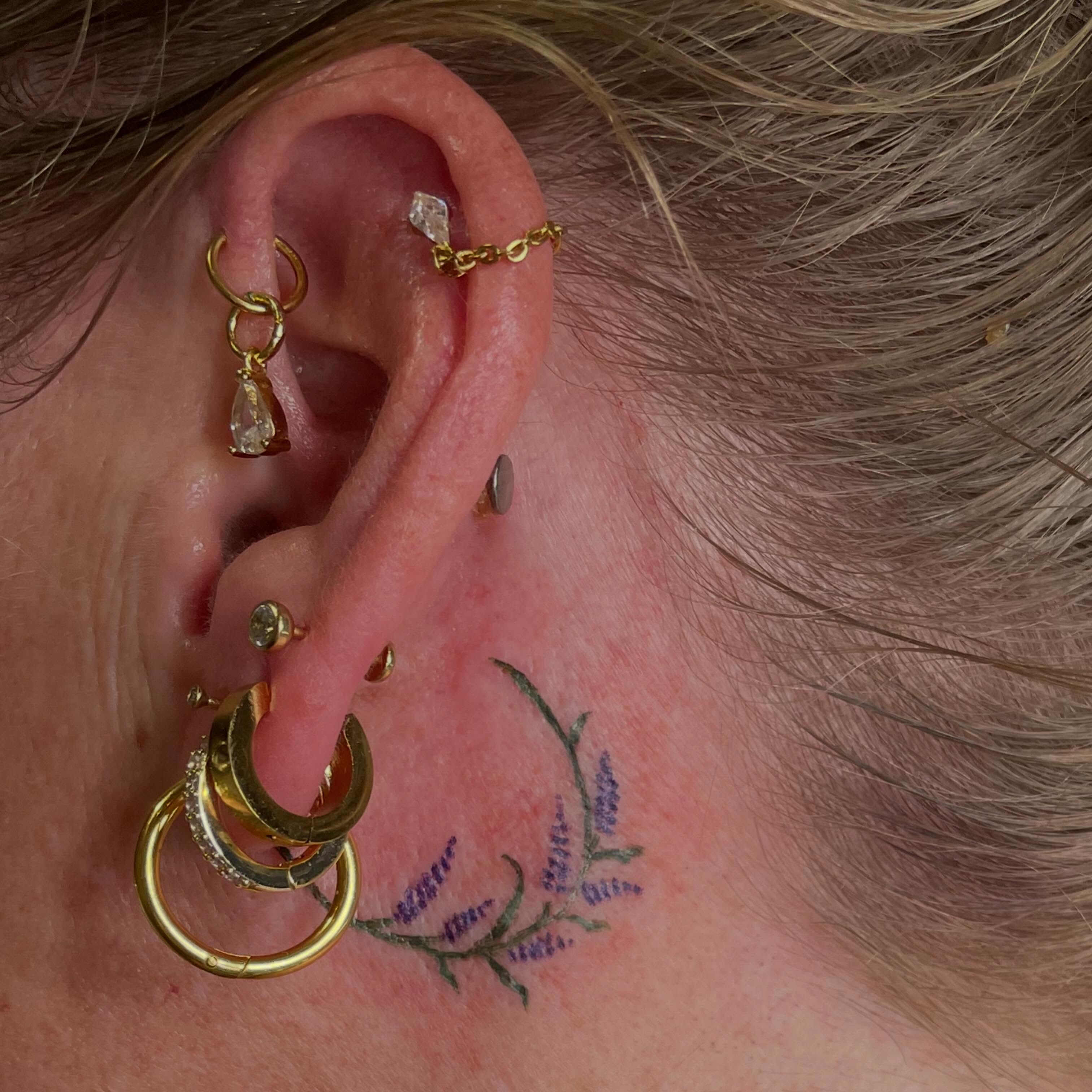 Purple flowers dotwork tattoo on the neck by Avalon Sable