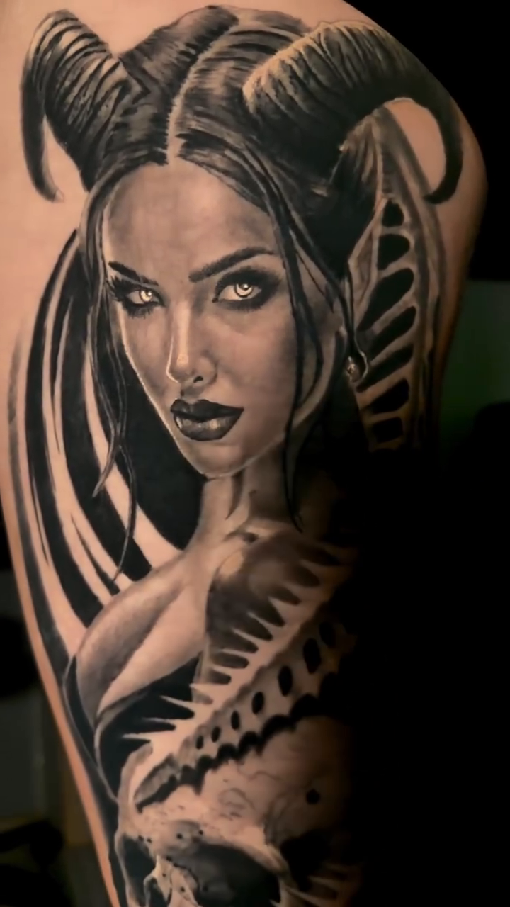 Demon woman and skeleton realism tattoo on the upper arm by Antonio Massimino