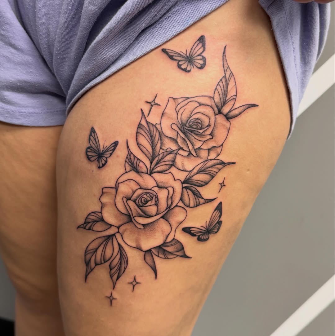 Roses and butterflies black and grey tattoo on the thigh by Katie Rojas