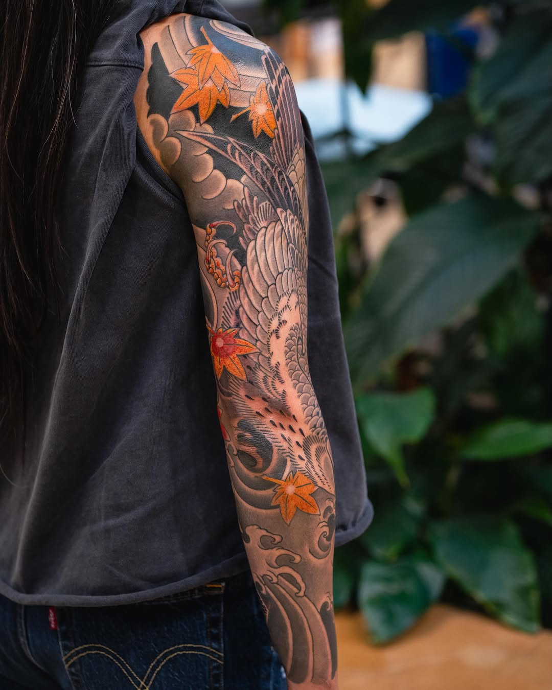 Crane and maple leaves Japanese tattoo on the upper arm by Matt Leibo, San Francisco, California