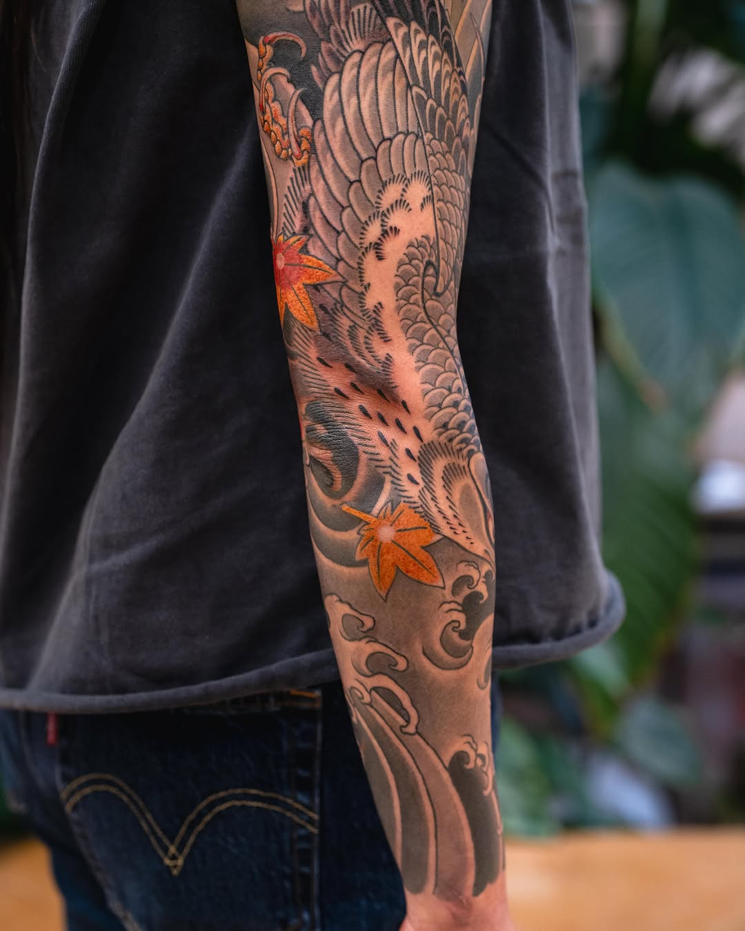 Crane and maple leaves Japanese tattoo on the forearm by Matt Leibo, San Francisco, California
