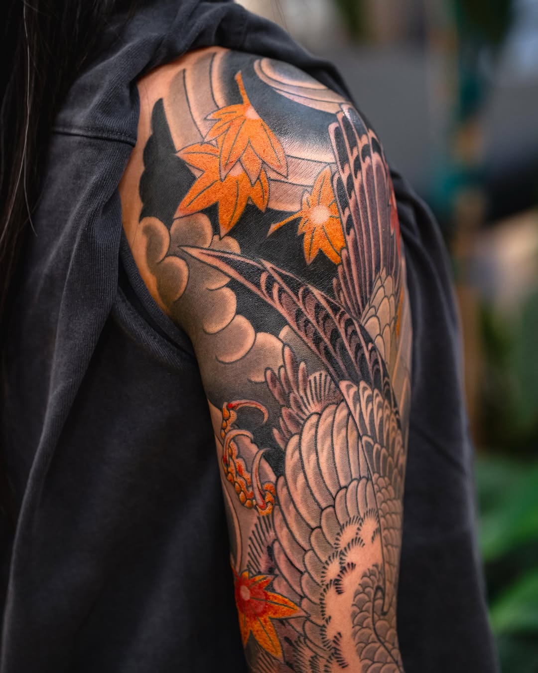 Crane and maple leaves Japanese tattoo on the upper arm by Matt Leibo, San Francisco, California
