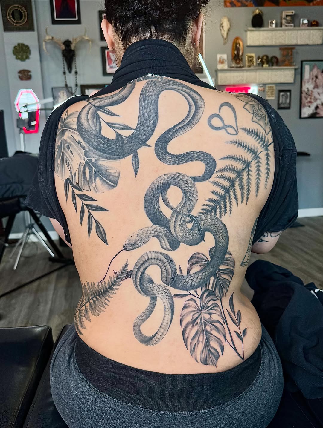 Snake and foliage tribal tattoo on the back by Stephanie Cruz, Kansas City, Missouri