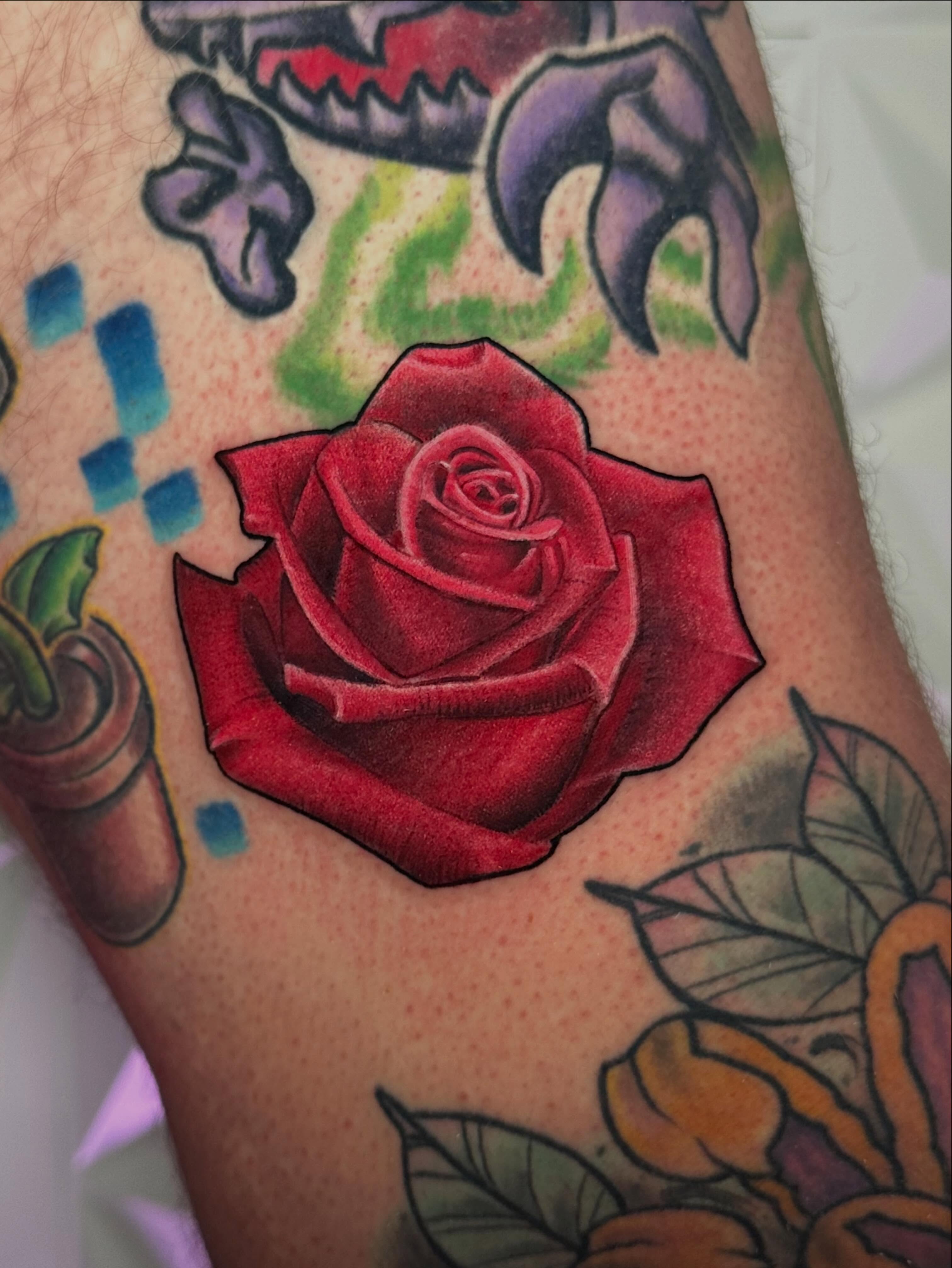 Red rose realism tattoo on the forearm by Chi, Charlotte, North Carolina